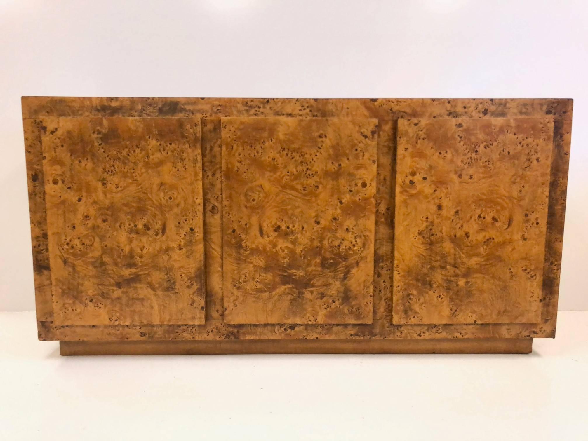 Milo Baughman style credenza, cabinet in burl wood. The credenza has two adjustable shelves with three drawers.
