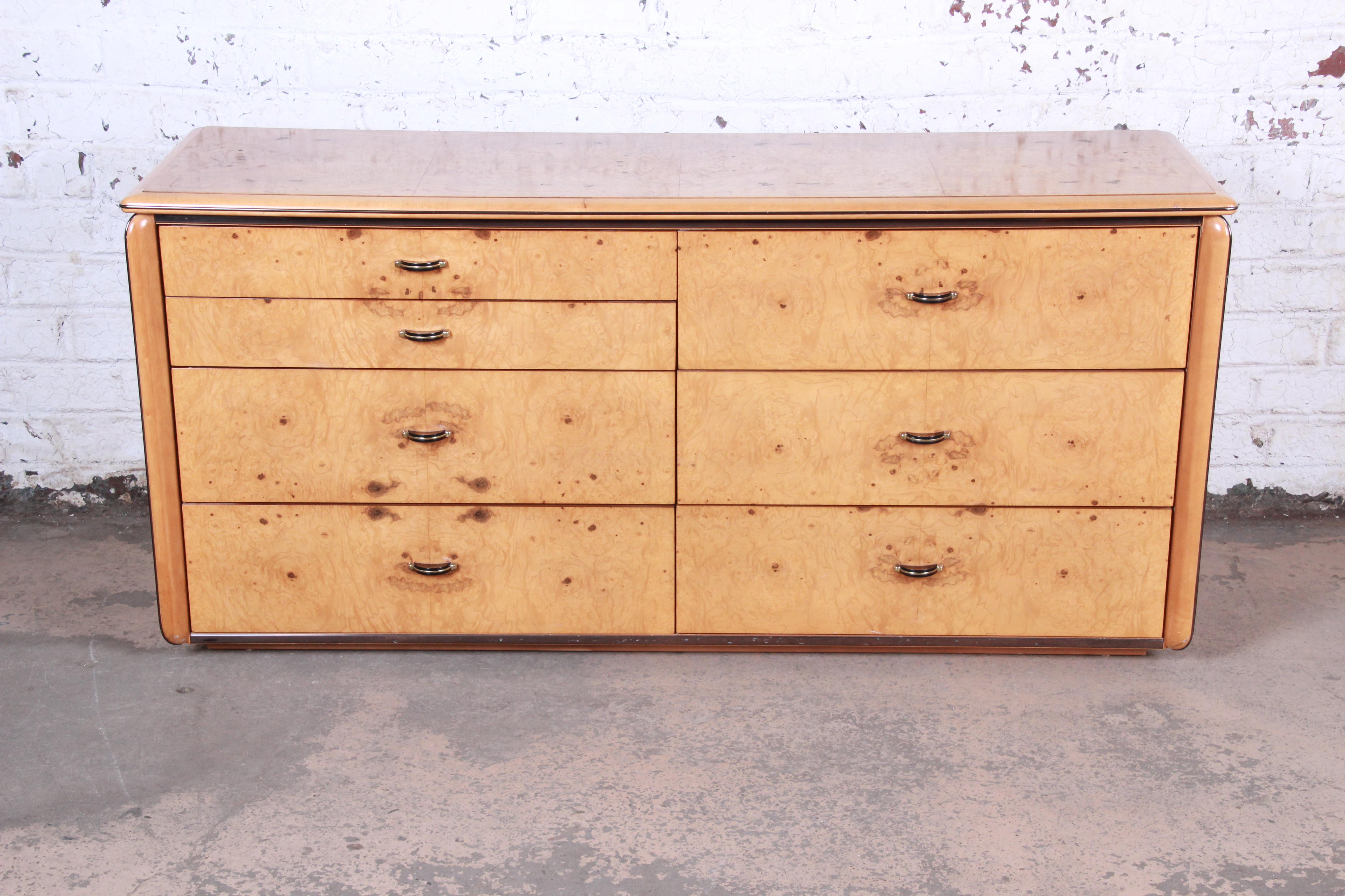 A gorgeous Milo Baughman style Mid-Century Modern burl wood long dresser or credenza

By Lane Furniture

USA, circa 1970s

Olive ash burl + ebonized wood + brass

Measures: 64.75