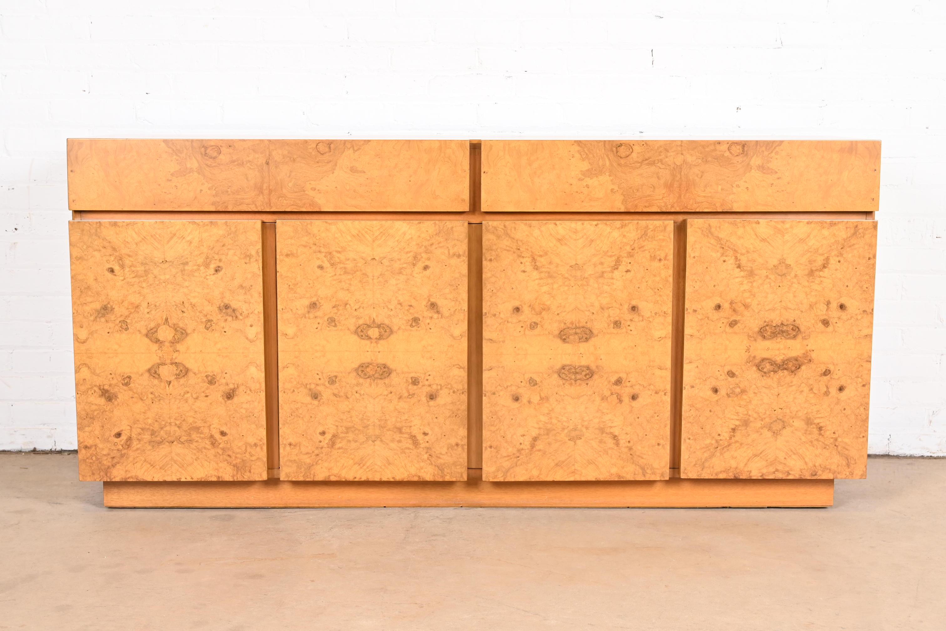 A gorgeous Mid-Century Modern sideboard, credenza, or bar cabinet

In the manner of Milo Baughman

By Lane Furniture

USA, 1970s

Beautiful book-matched burled olive wood, with ash wood case.

Measures: 67.75