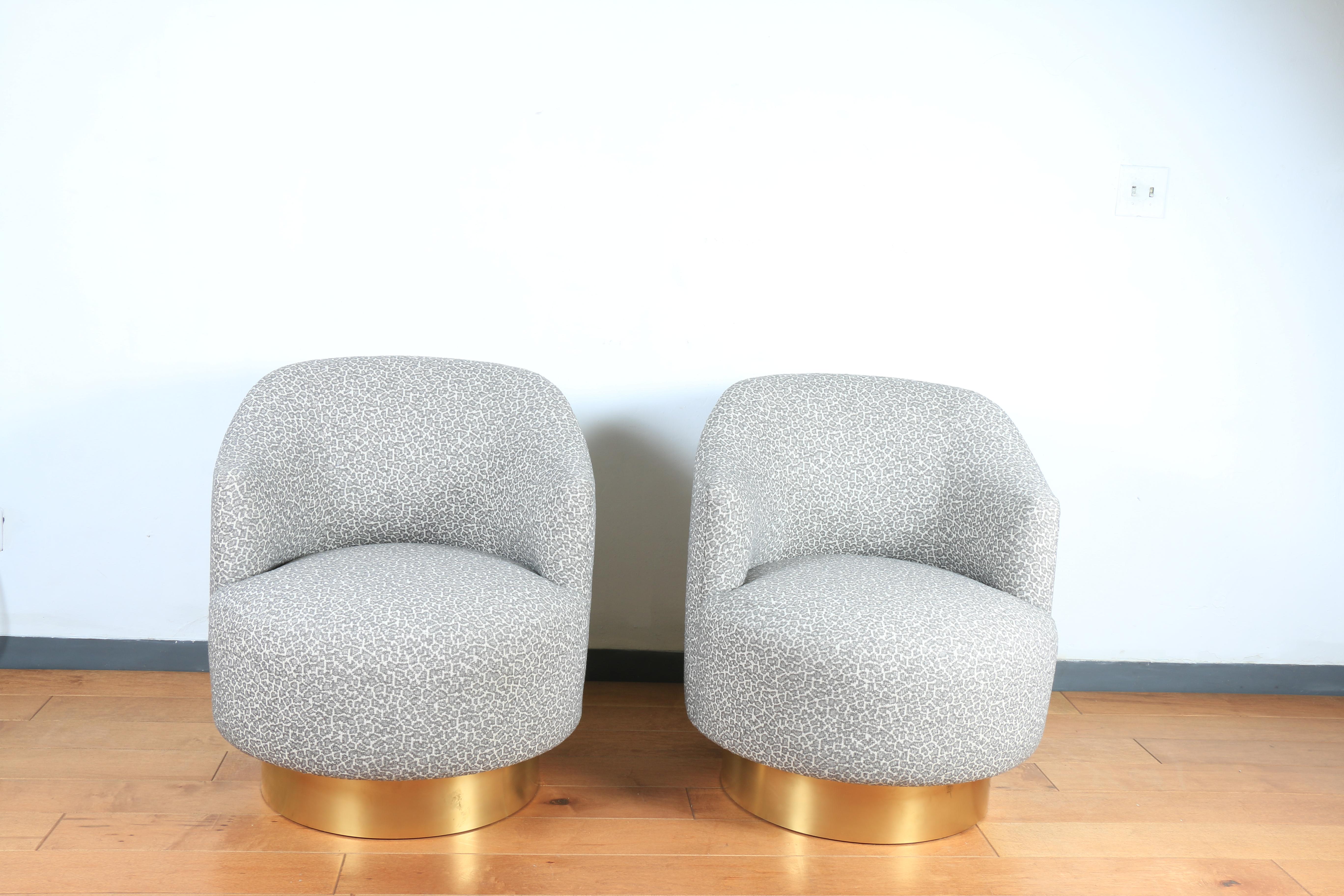 Milo Baughman-style chairs with brass base. These chairs are round and have a round brass base as well. They are used as side chairs. Both chairs have been reupholstered and clean. Cute and comfortable design. Brass swivel bas is well kept.