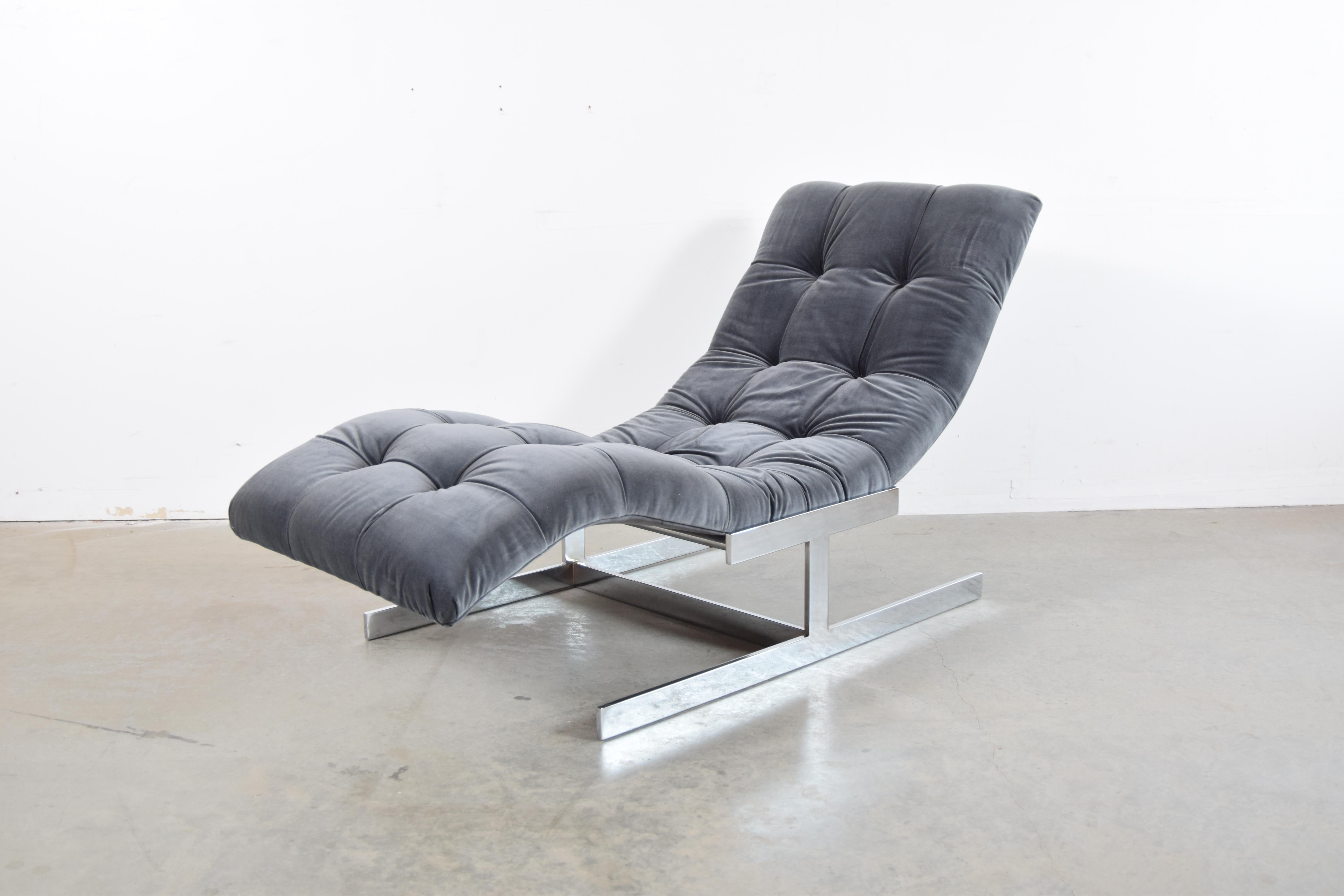 Upholstered chaise lounge, with chrome base, circa 1976. Chaise Lounge has been completely re-upholstered in a dark grey velvet. All foam and other internals have also been replaced. Chaise measures 56 1/2