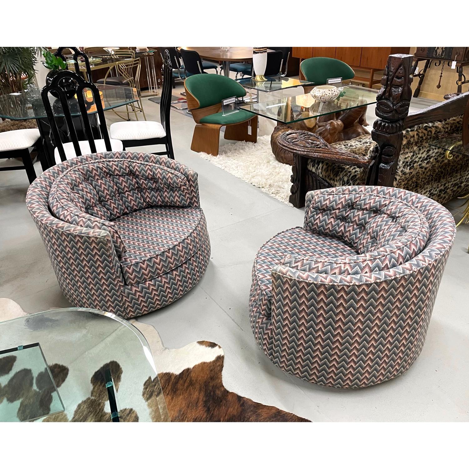 Elegant pair of Milo Baughman style vintage tub chairs with swivel base. These chairs were updated some time in the early 90s with it’s current chevron fabric. The pattern is a chevron ombre with graduating tones of mauve, gray, and blue. Arguably