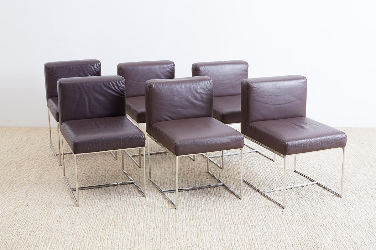 Stylish set of six Milo Baughman style chrome and leather dining chairs featuring a chocolate colored brown leather upholstery. The bases are constructed from round tubular shaped chrome with a flat stretcher in the middle. Thick cushioned seat and