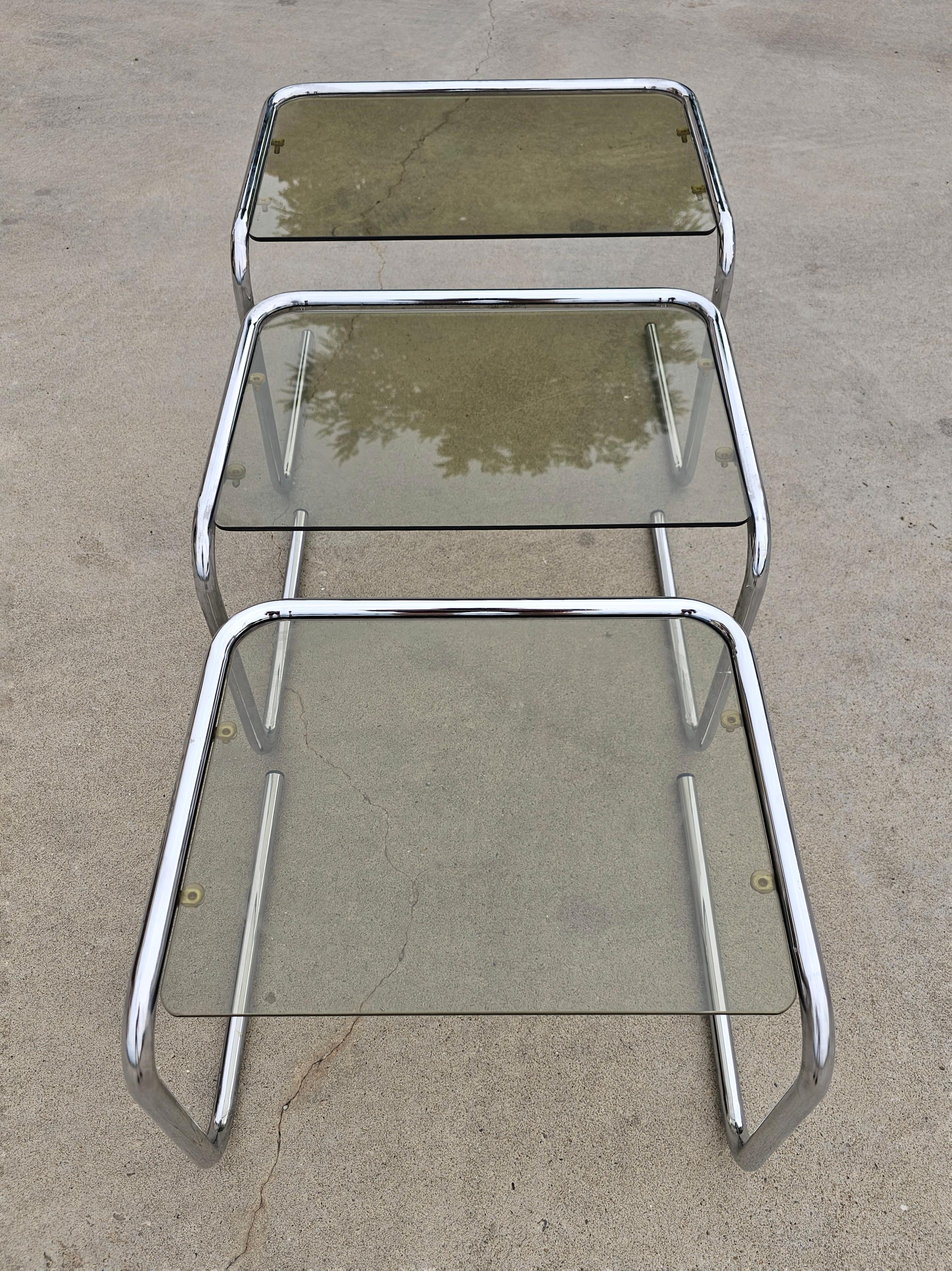 This listing features vintage set of 3 beautiful mid century modern chrome and smoked glass nesting tables attributed to Milo Baughman. Perfect for small apartments or corner areas in your home and very stylish and elegant. 

Italian sleek design
