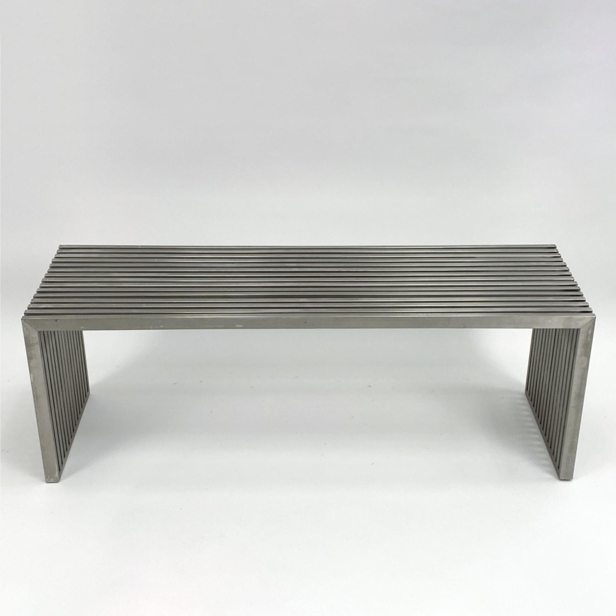 Sleek modernist metal slat bench in the manner of Milo Baughman. Chrome plated metal with lucite spacers. The length of this bench measure 47