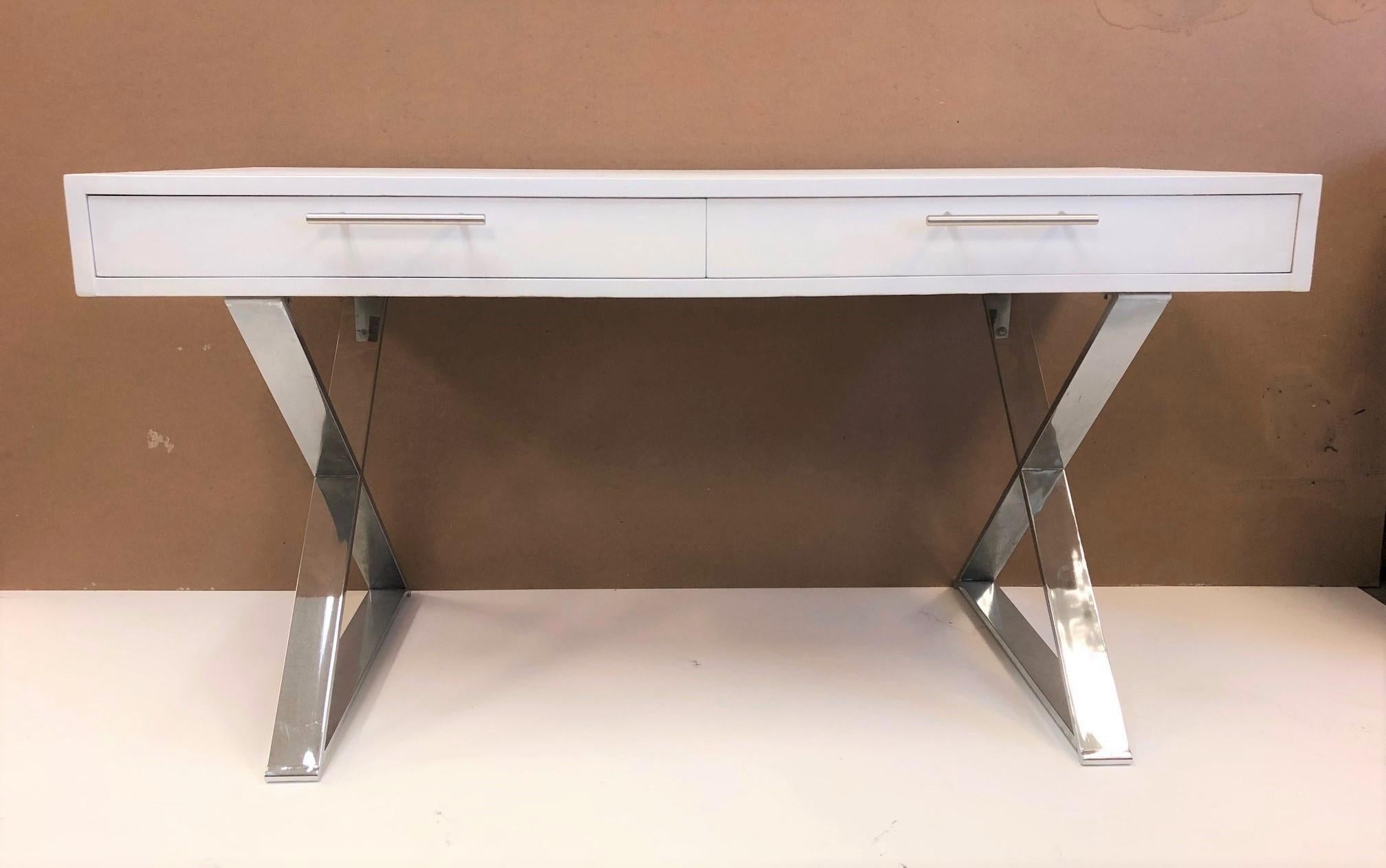 Milo Baughman style desk. The desk has a white painted finish, chrome X base, and two pull out drawers. Handles are chrome as well. Leg room is 23H.