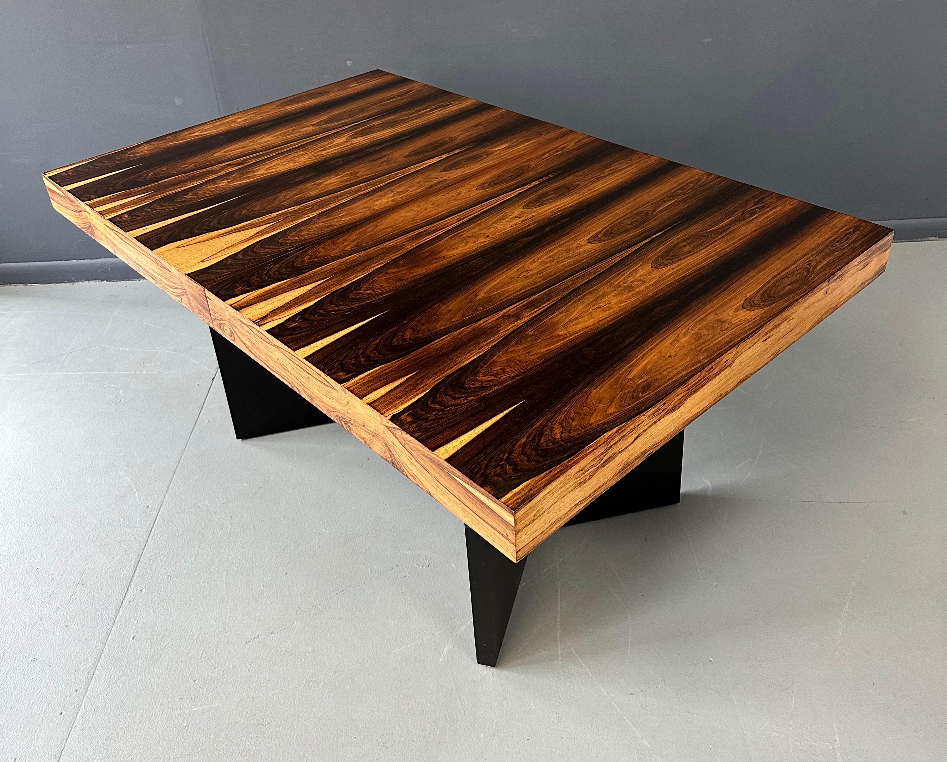 Beautiful dining table in a wonderfully unusual Marabunda Veneer. Sitting on two triangular legs deep brown in color, this table comes with one leaf that is 15