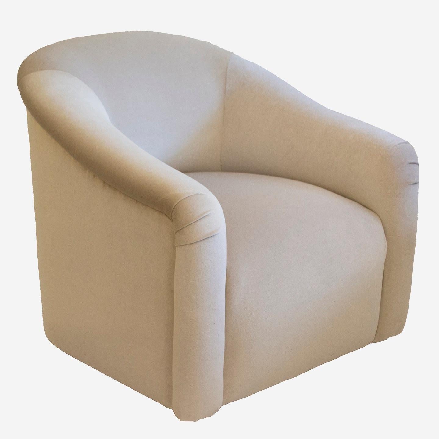 Pair of mid century swivel club chairs in the style of Milo Baughman. They are freshly reupholstered in imported velvet in a lovely cream color. Stunningly elegant, they are suitable for any living space. Generously proportioned with a swivel base,