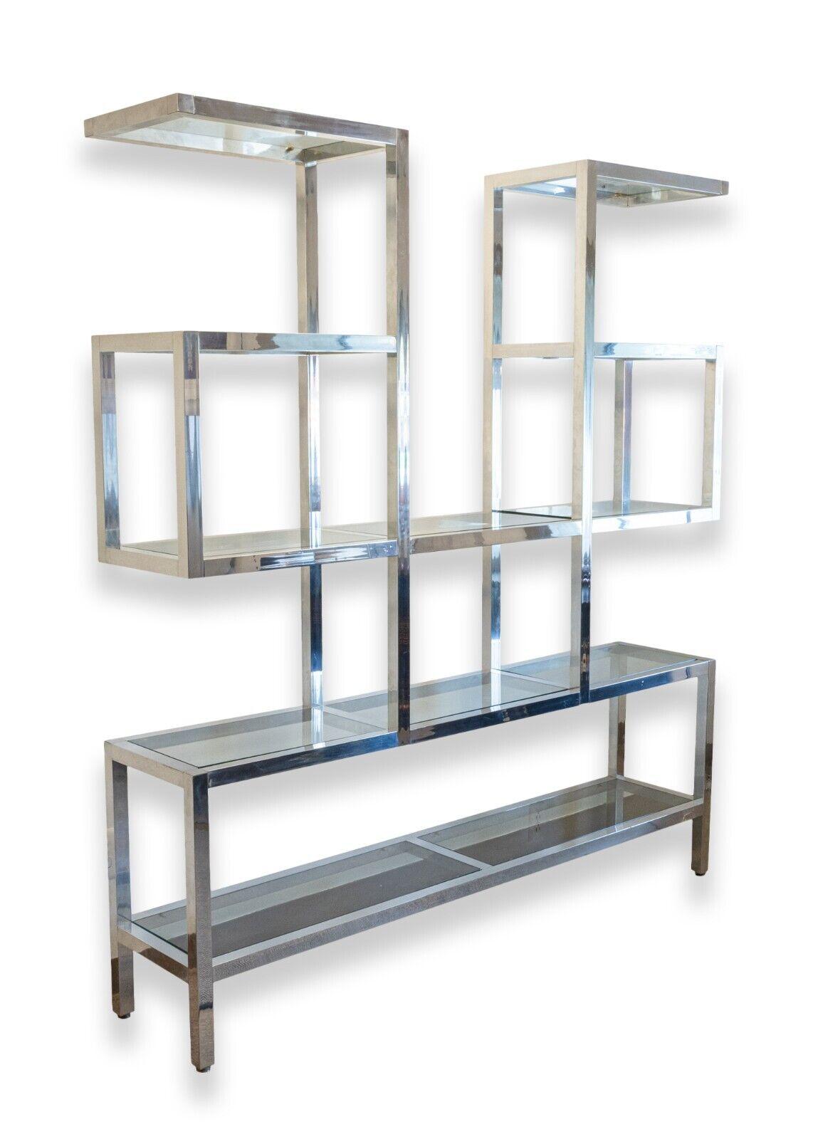 Elevate your home decor with this stunning Milo Baughman Style Large Chrome and Glass Floating Etagere Shelving Wall Unit. Crafted from high-quality glass and chrome finished metal, this contemporary/modern style shelving unit is a perfect addition