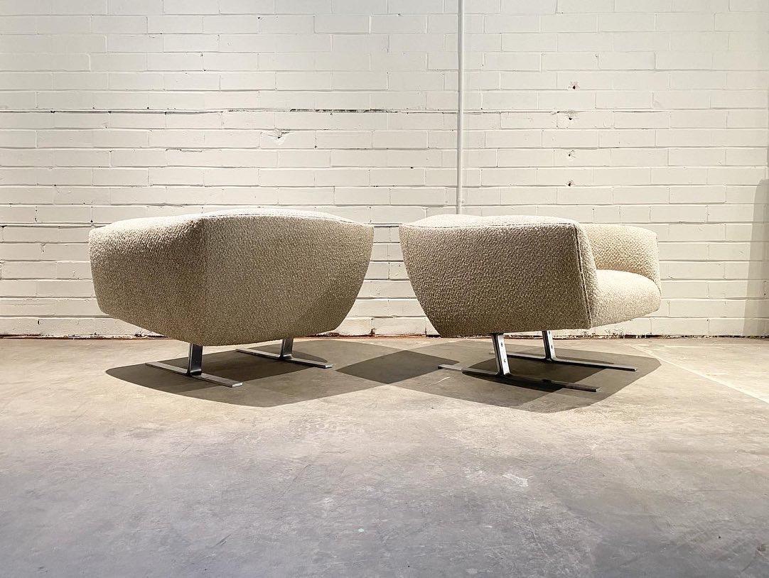 A unique pair of lounge chairs with a Space Age look reminiscent of Milo Baughman designs. These are very wide and sit low. New foam and upholstery offer great comfort and a clean look. The new boucle fabric is a nice contrast to the brushed steel