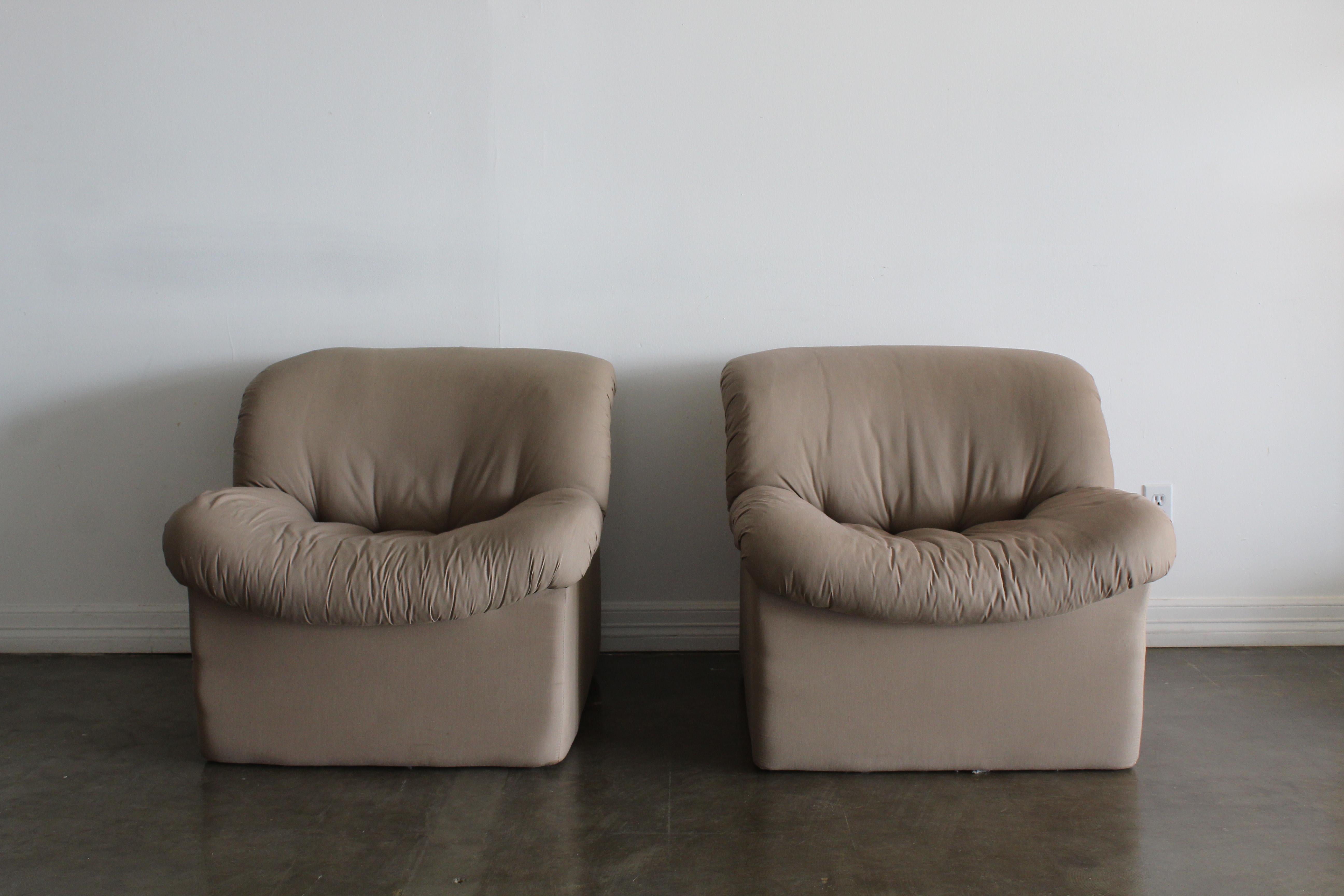 Milo Baughman style lounge chairs in a light tan fabric. Pieces are from the postmodern era, very light weight in a foam style material. super soft and comfortable! A great addition to any space.