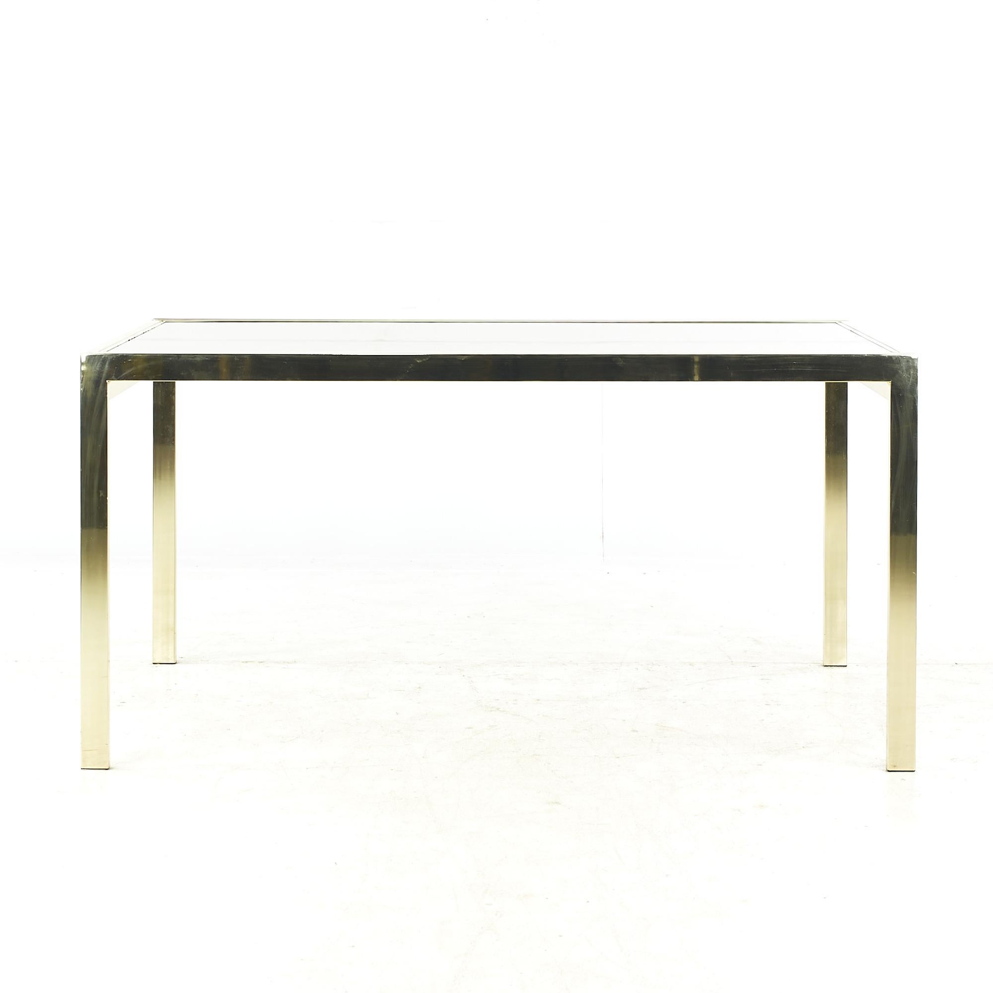 Milo Baughman Style Mid Century Brass and Smoked Glass Extension Dining Table

This table measures: 60 wide x 40 deep x 30 high, with a chair clearance of 26 inches, when fully extended the width of the table is 120 inches

All pieces of furniture