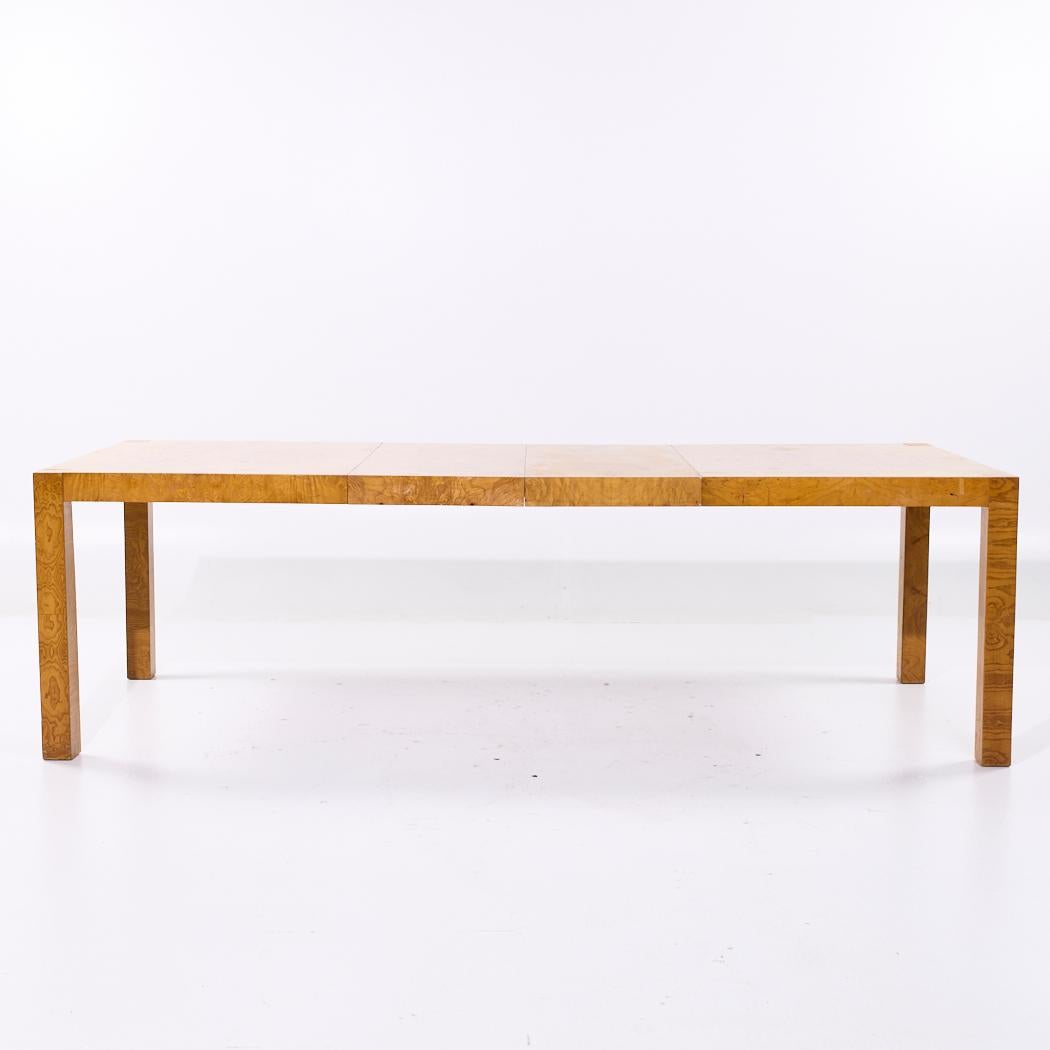 Milo Baughman Style Mid Century Burlwood Expanding Dining Table with 2 Leaves

This table measures: 64.25 wide x 40.25 deep x 30 inches high, with a chair clearance of 27 inches, each leaf measures 18 inches wide, making a maximum table width of