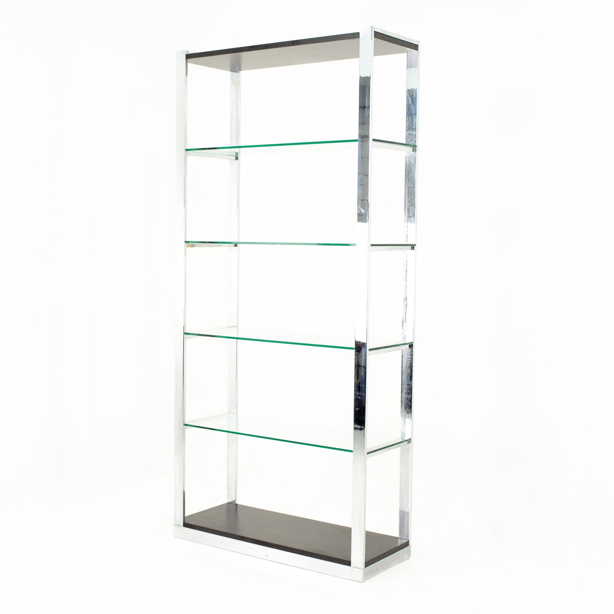 Milo Baughman style Mid Century chrome and glass shelf
Shelf measures: 36 wide x 14 deep x 78 high

This price includes getting this set in what we call restored vintage condition. Upon purchase it is fixed so it’s free of watermarks, chips or deep