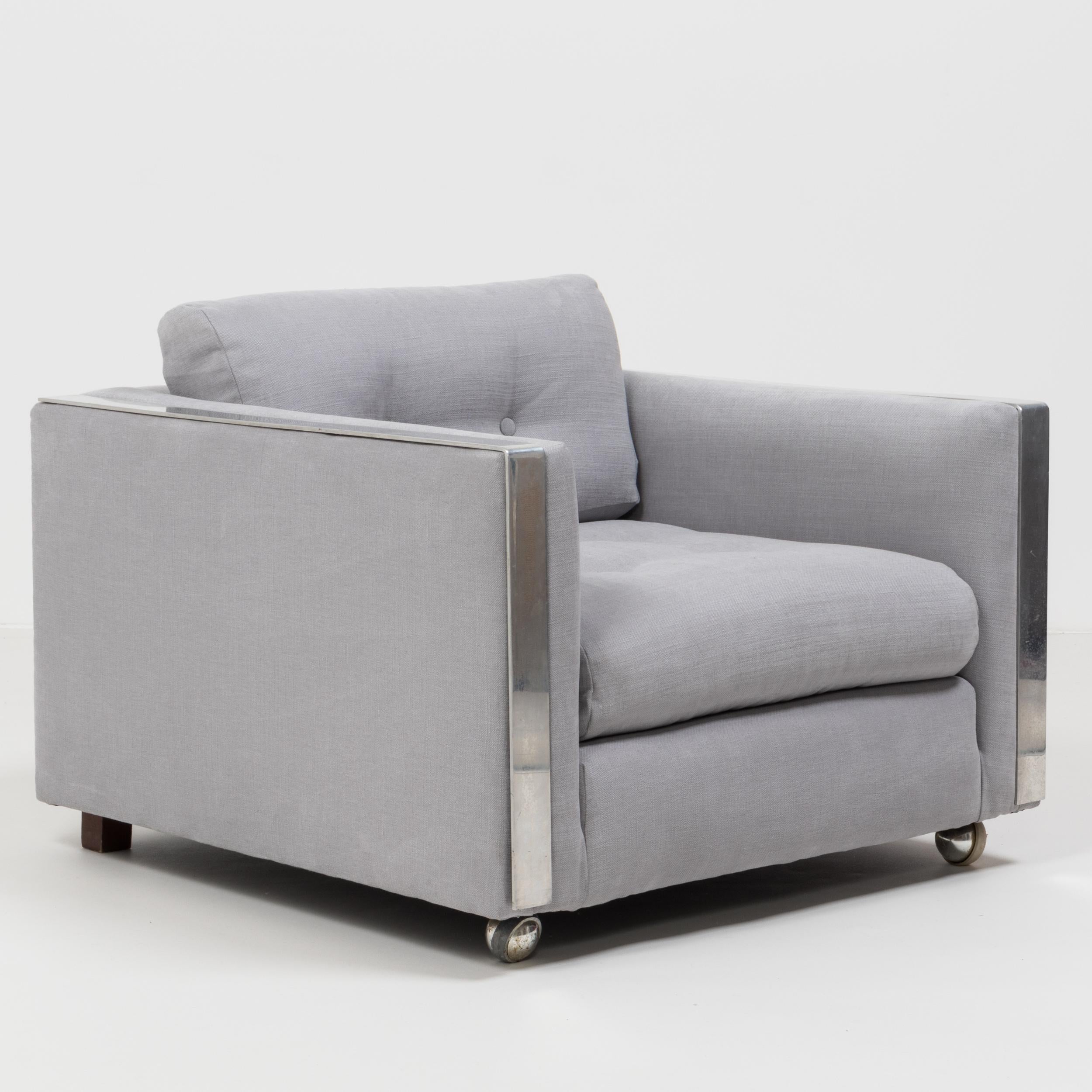 Designed in the style of Milo Baughman, this sleek mid century armchair has been newly upholstered in a sumptuously soft and airy grey Linara fabric that compliments the chrome detailing perfectly.
 
With its clean lines and cool aesthetic it