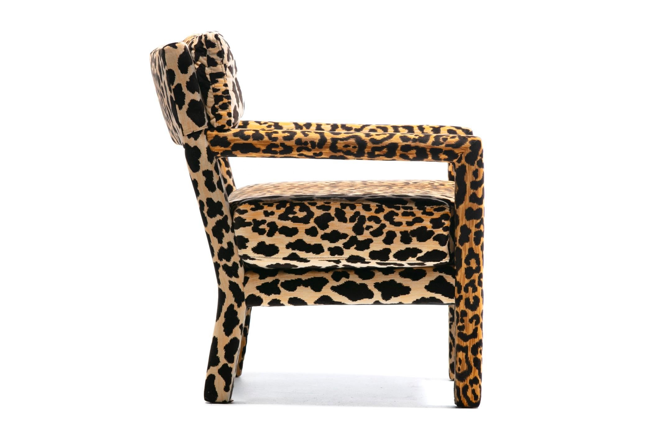 Envelop yourself in all over cushioned leopard velvet bliss in this 1970s Milo Baughman style Parsons chair freshly reupholstered in forever sexy and stylish leopard velvet. This particular Parsons style chair offers an open lower seat back that