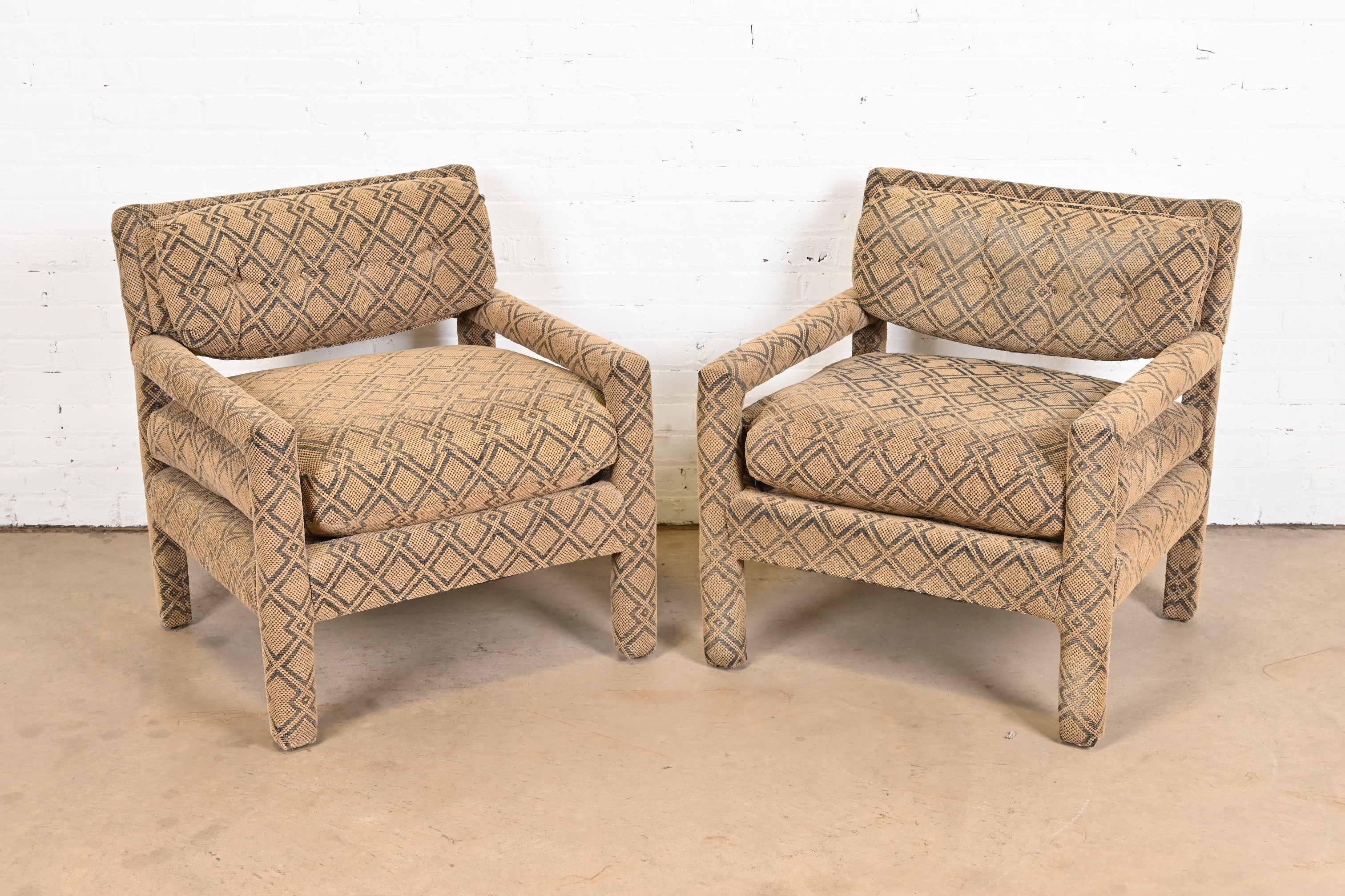 A gorgeous pair of Mid-Century Modern armchairs, club chairs, or lounge chairs in original African Kuba cloth style upholstery.

In the style of Milo Baughman

USA, circa 1970s

Measures: 28.5