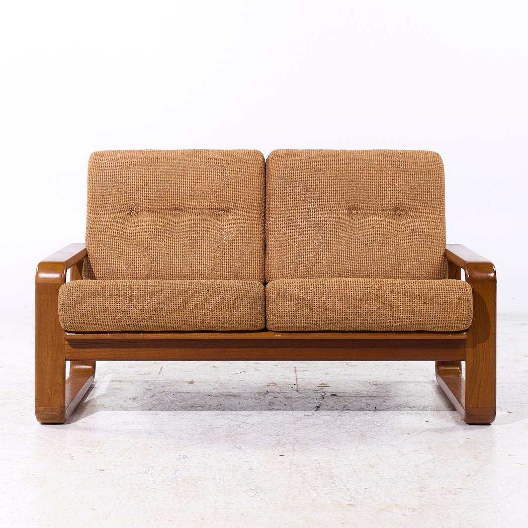 Milo Baughman Style Mid Century Teak Settee

This settee measures: 54.5 wide x 33 deep x 32.5 inches high, with a seat height of 17 and arm height of 19.5 inches

All pieces of furniture can be had in what we call restored vintage condition. That