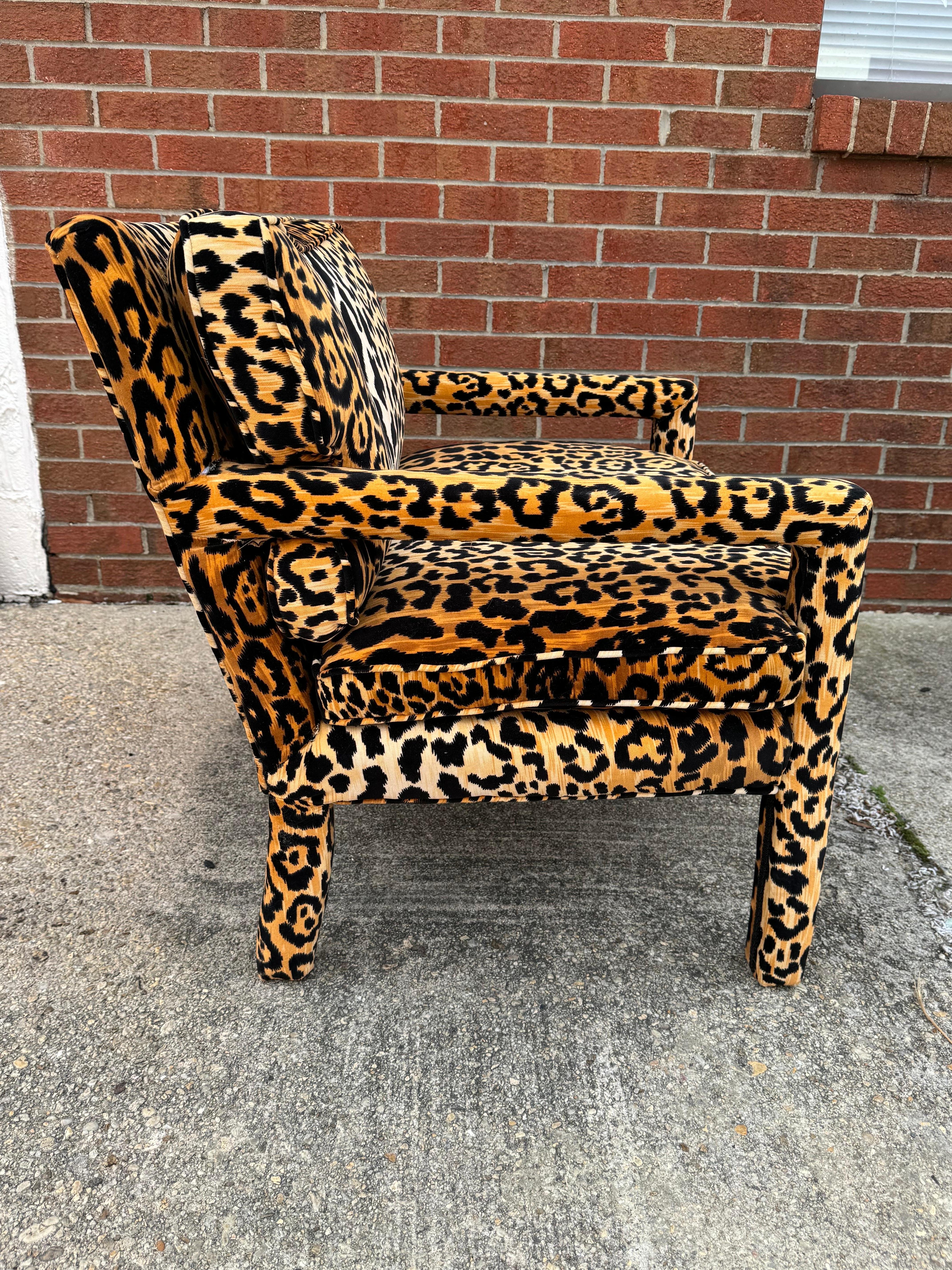 Modern version of the timeless Milo Baughman Parsons style chair  with forever sexy and stylish leopard upholstery . Parsons chairs are unique in that every surface is upholstered - every inch of this arm chair is padded and covered in spots. The