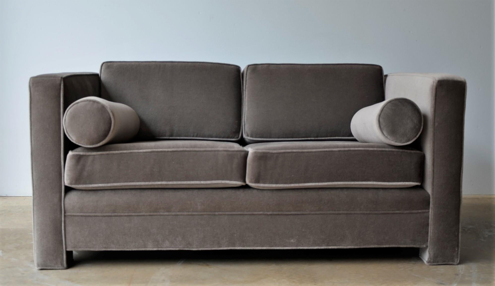Offered is a Mid-Century Modern Milo Baughman style newly upholstered mohair wool tuxedo love seat in a warm gray or taupe color way. The piece is a two-seat sofa with two-seat cushions and two back cushions and two rolled armrest cushions. The sofa