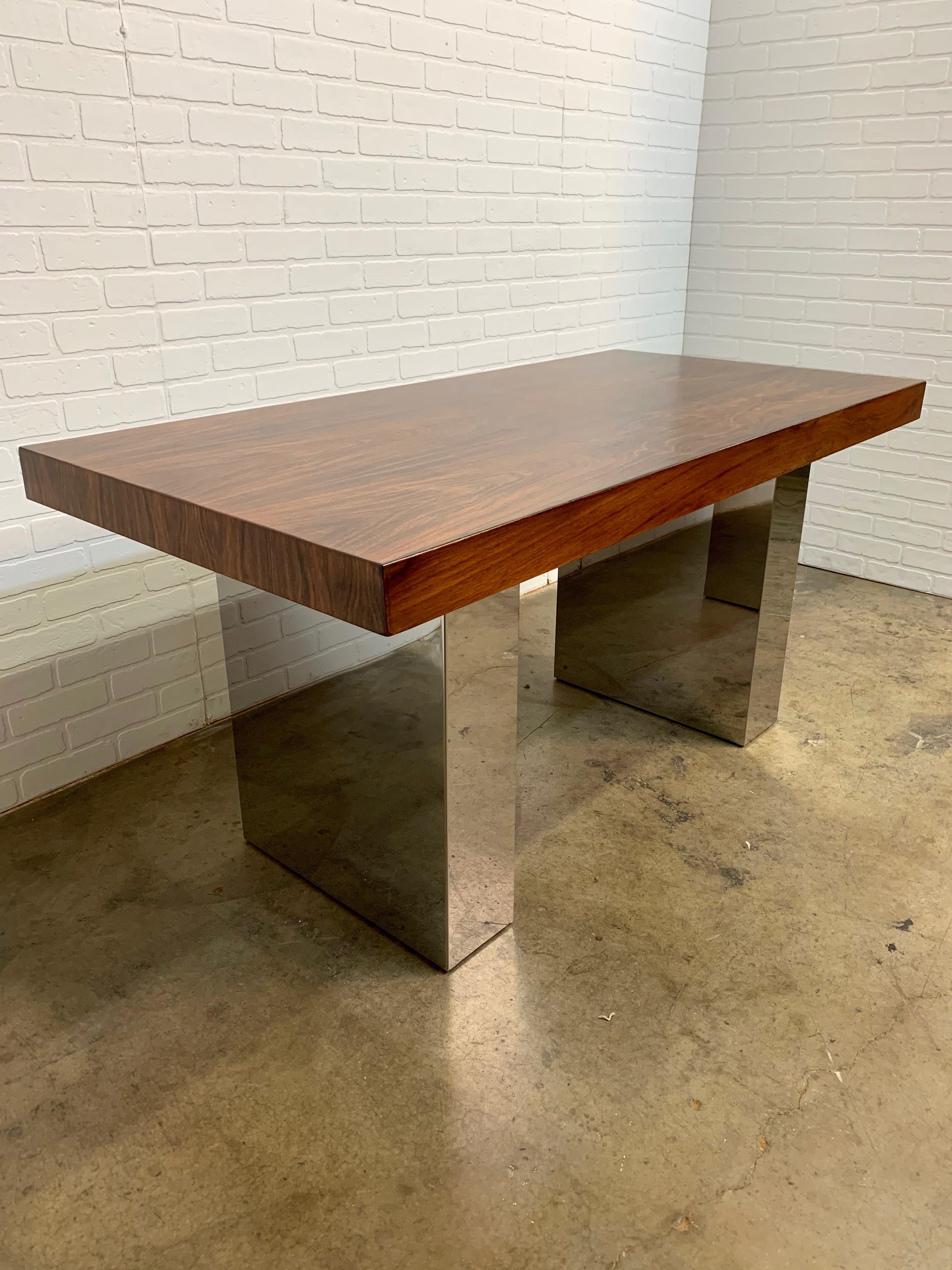 Rosewood with chrome pedestal base library table that can be used as a dining table or foyer table or desk.
