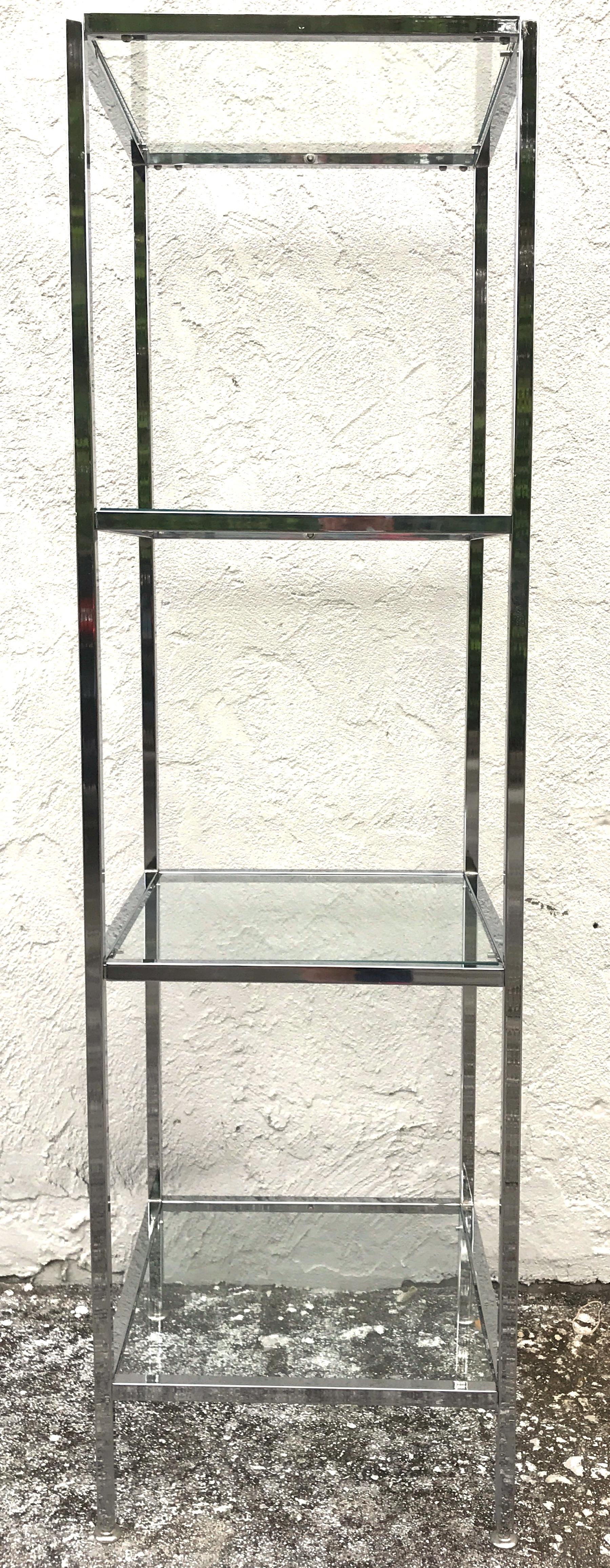 Milo Baughman style tall chrome and glass column étagère, 
Each one fitted with four 17 inch square clear glass shelves. Each cube shelf has a display height of 17.5