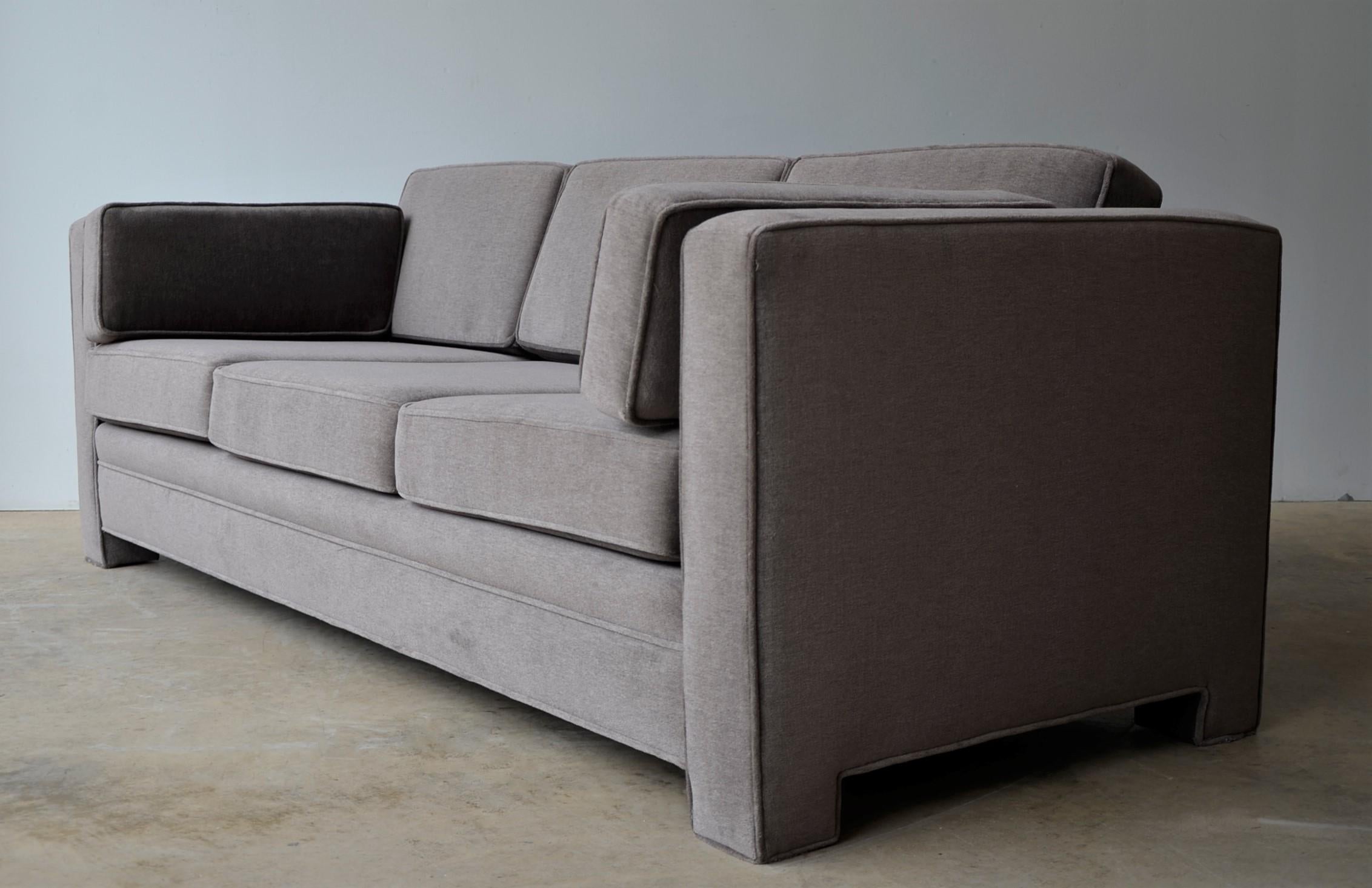 Offered is a Mid-Century Modern Milo Baughman style newly upholstered mohair wool tuxedo sofa in a warm gray or mink brown color way. This piece is a three-seat sofa with three-seat cushions and three back cushions and two armrest cushions. The sofa