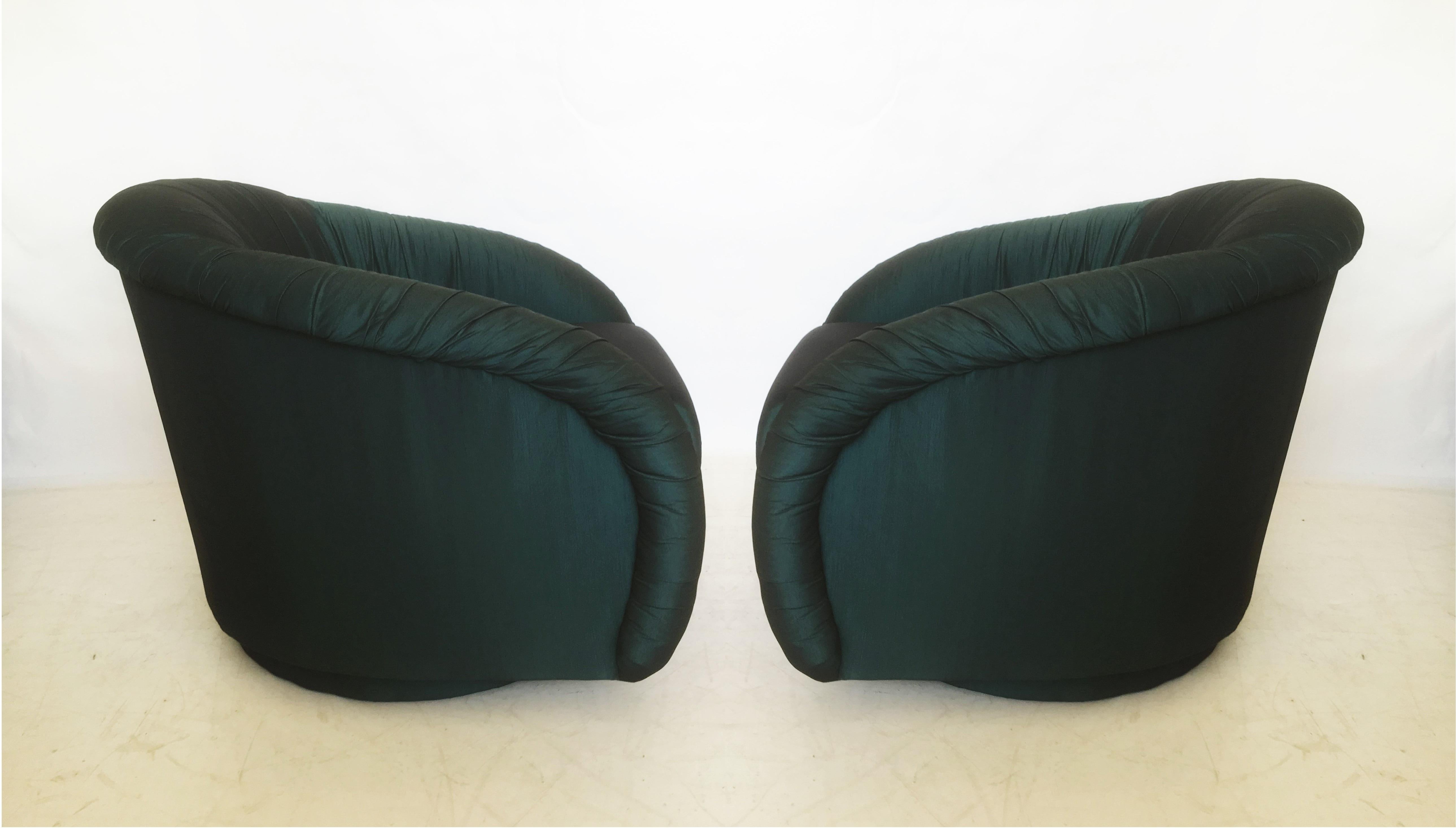 Matching pair of stylish and very comfortable lounge chairs, Milo Baughman Style from the early 1980s. Each custom upholstered swivel chair, barrel back style, covered in a gorgeous green fabric. The backs of the chairs are upholstered in a solid