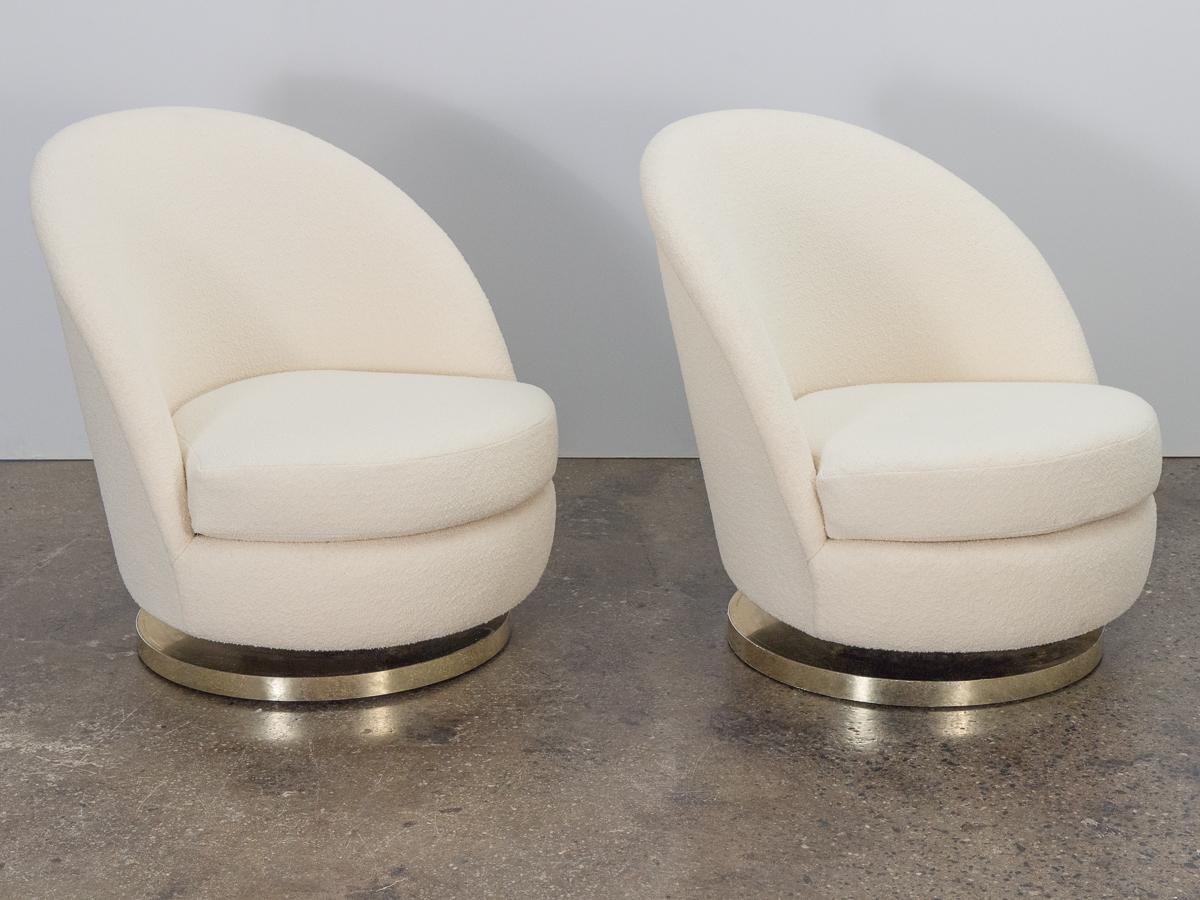 Pair of glamorous 1960s swivel lounge chairs by Milo Baughman for Thayer Coggin. These chairs have a tilt feature that makes them supremely comfortable. Gleaming bases have been restored with new brass plating. Newly recovered in luxurious Knoll