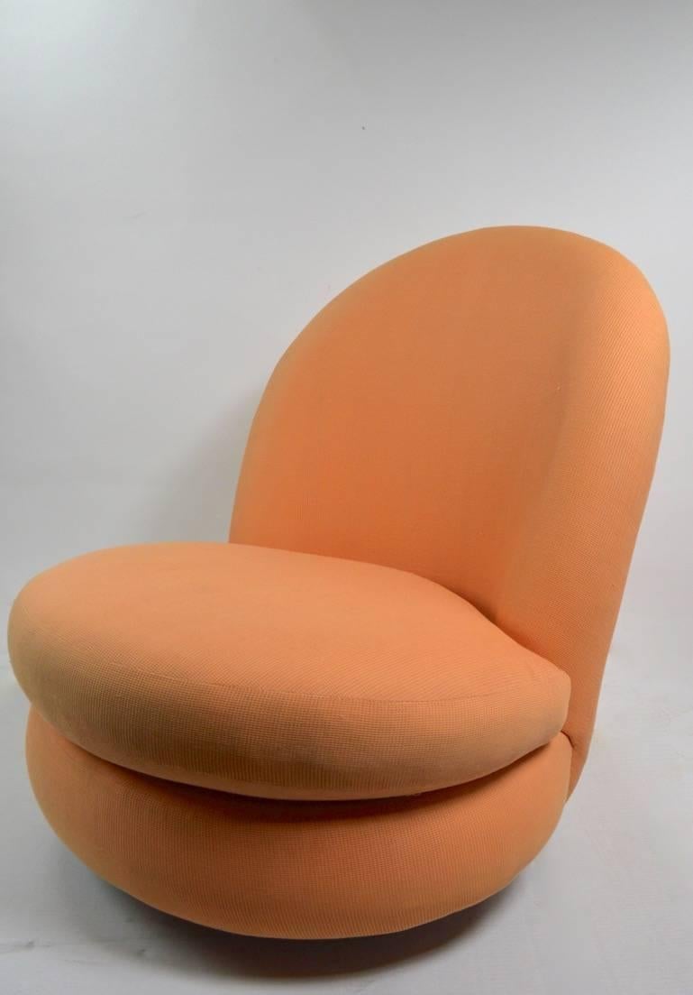Stylish and chic, swivel tilt lounge chair designed by Milo Baughman for Thayer Coggin. Original peach upholstery, thick and heavy chrome disk base. Fabric usable as is, but shows cosmetic wear, including some staining etc, normal and consistent