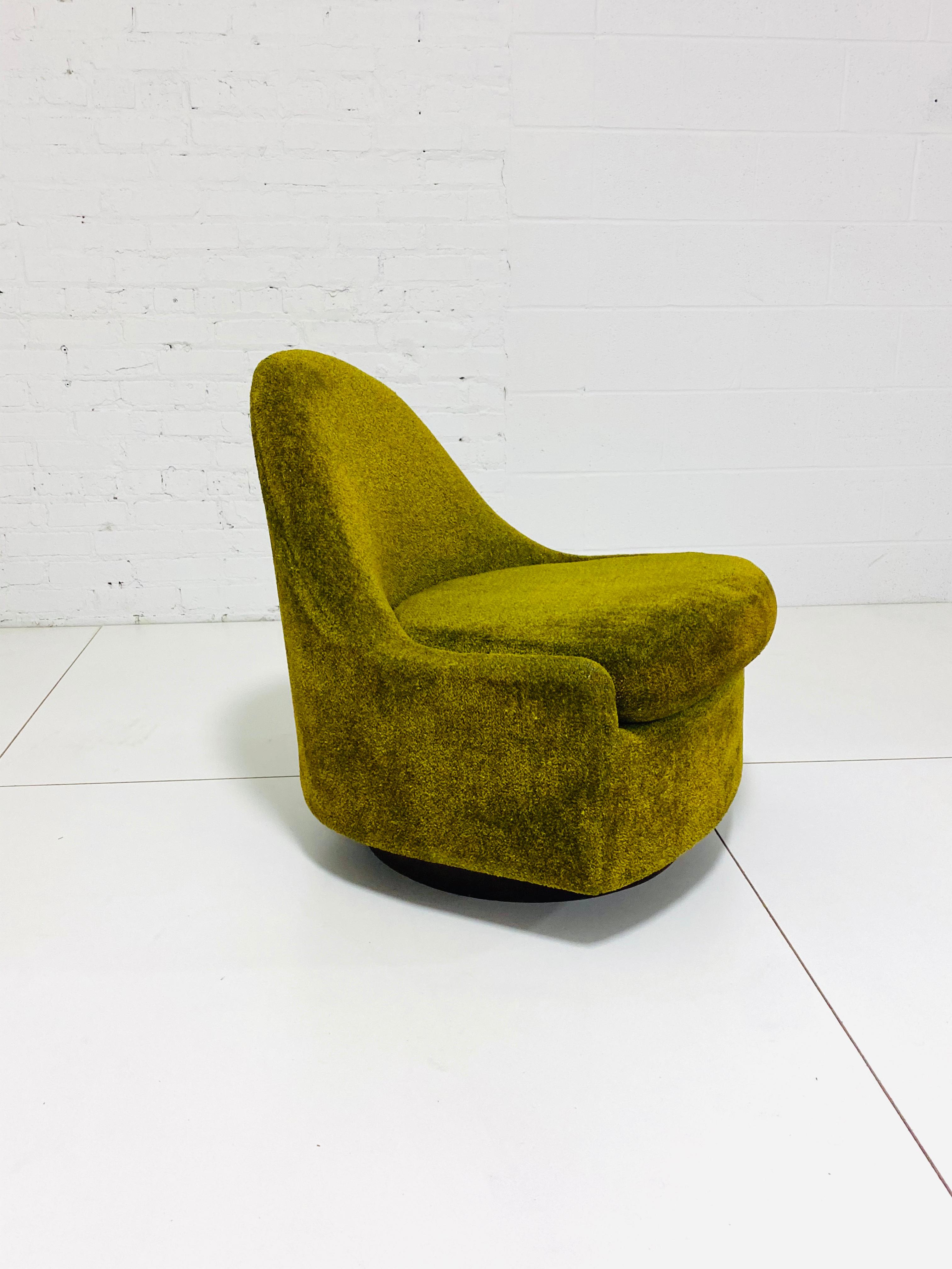Teardrop shape lounge chair by Milo Baughman. Unique petite form perfectly Contours body. Chair swivels and rocks.