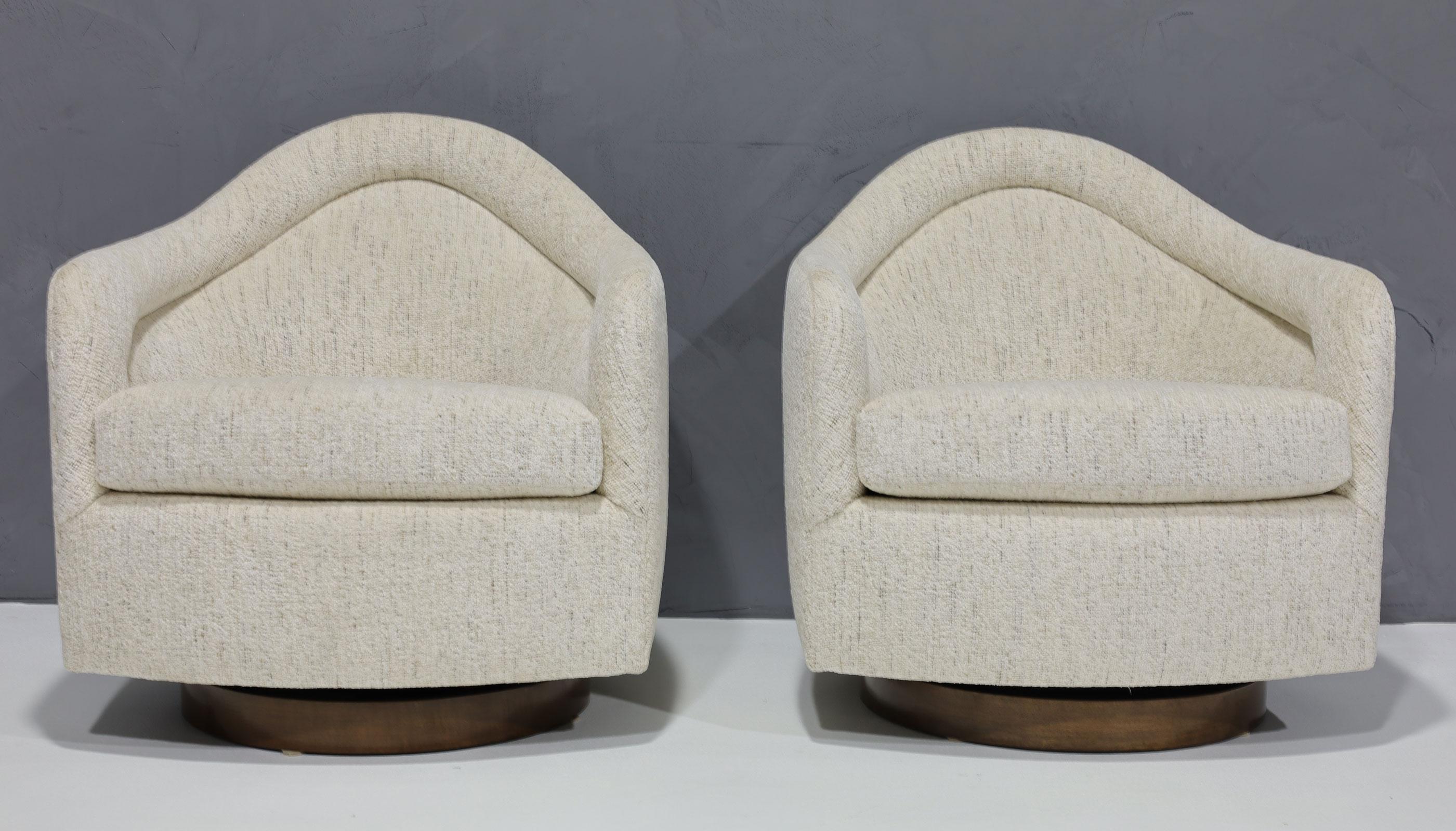 Super comfortable tilt/swivel chairs by Milo Baughman. Many love the higher back for support. We have reupholstered in a high quality chenille which is principally soft white with specs of black and brown throughout. The bases have new veneer in