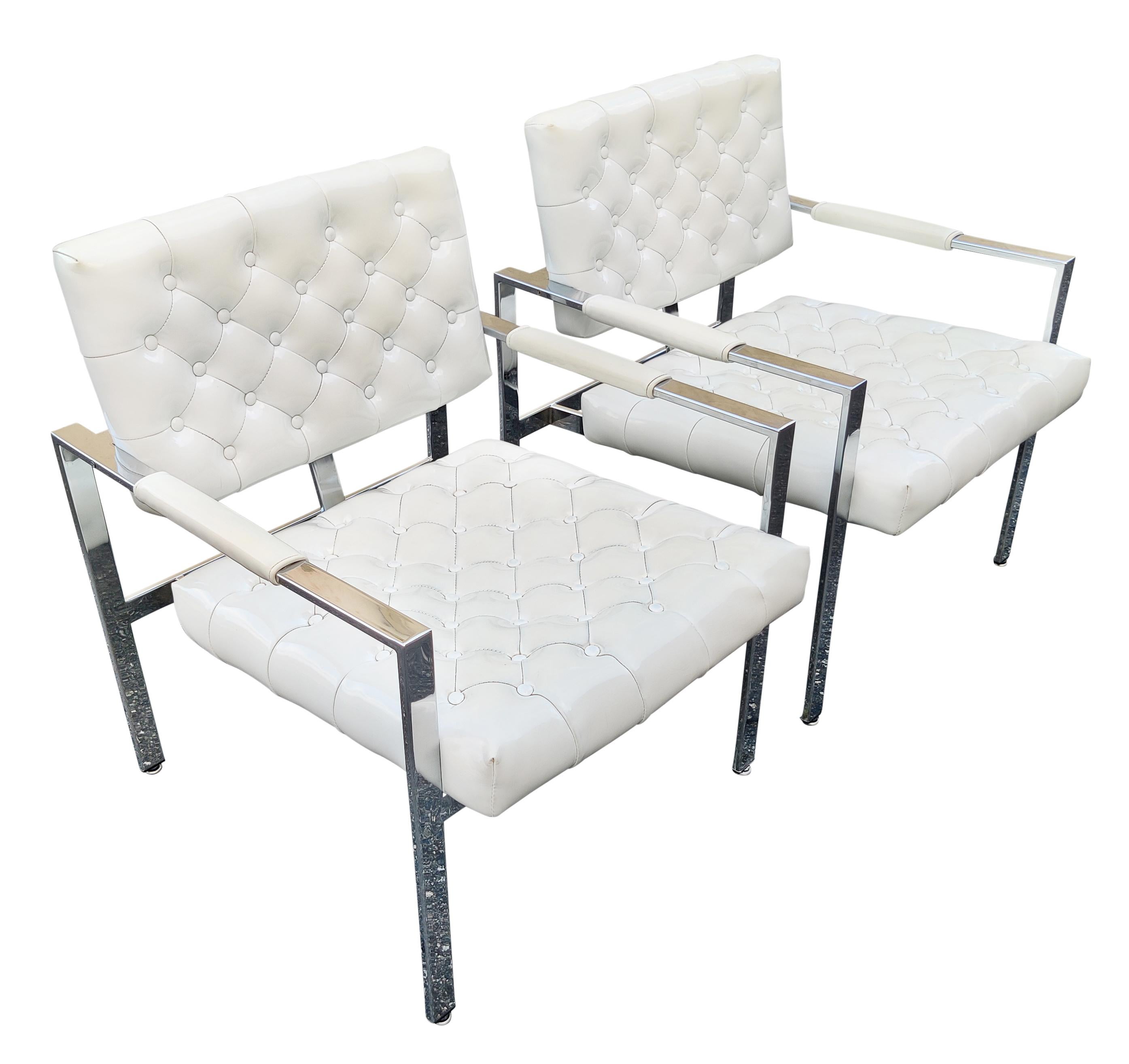 A very clean all original pair of armchairs or lounge chairs designed by Milo Baughman and manufactured by Thayer Coggin! This signed pair of chairs has super clean and bright chrome finished frames. The original slightly off white shinny vinyl