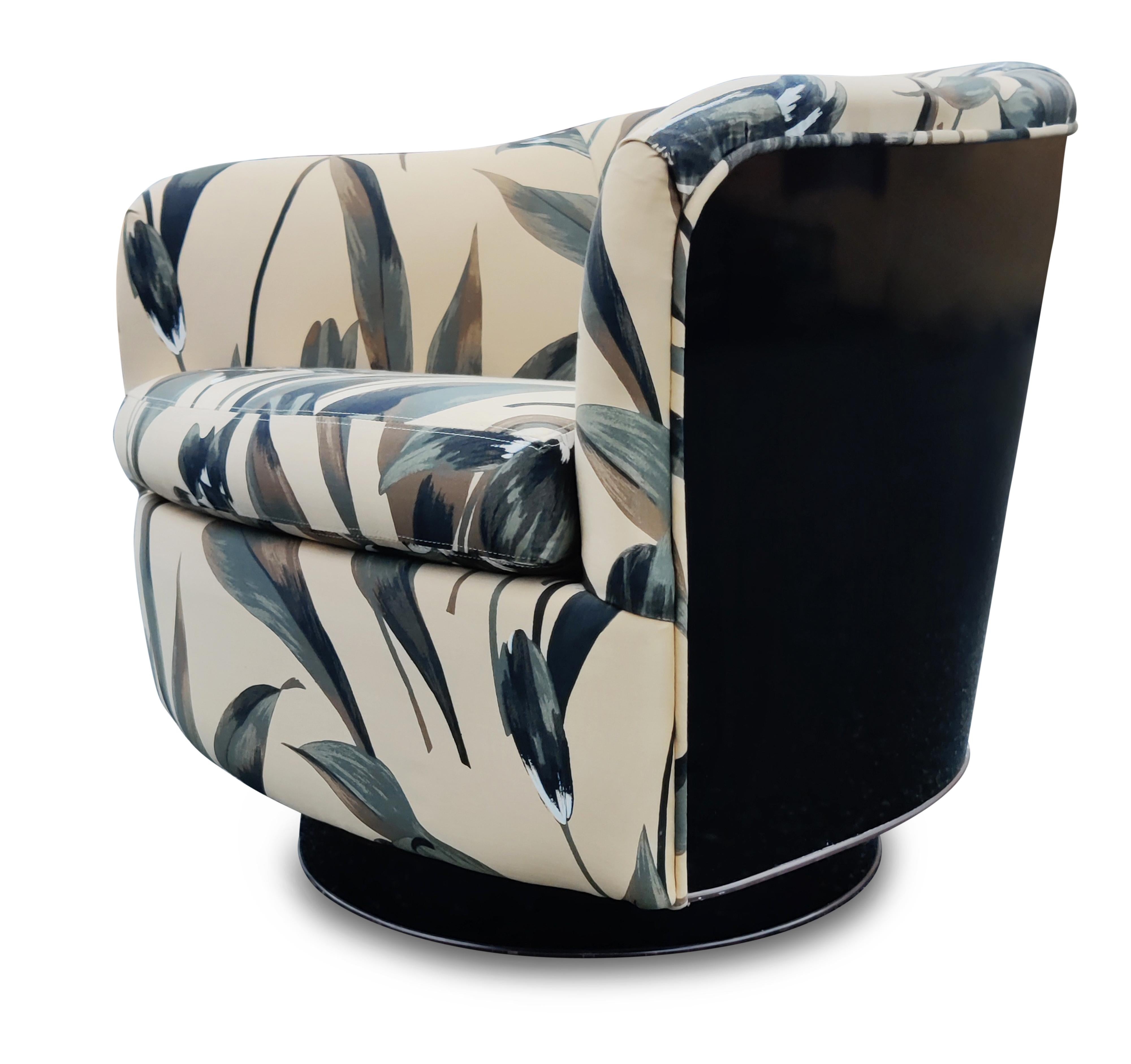 Designed by Milo Baughman for Thayer Coggin, this sexy chair is an absolutely iconic design. Theglossy black laminate backing is clean and bright and complements the warm patterned fabric very well. All of this sits on a laminate swivel