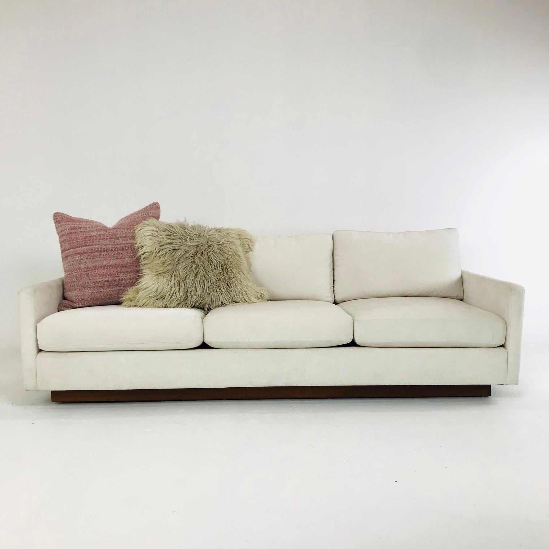 Newly upholstered Milo Baughman 3-seat sofa with walnut plinth base.