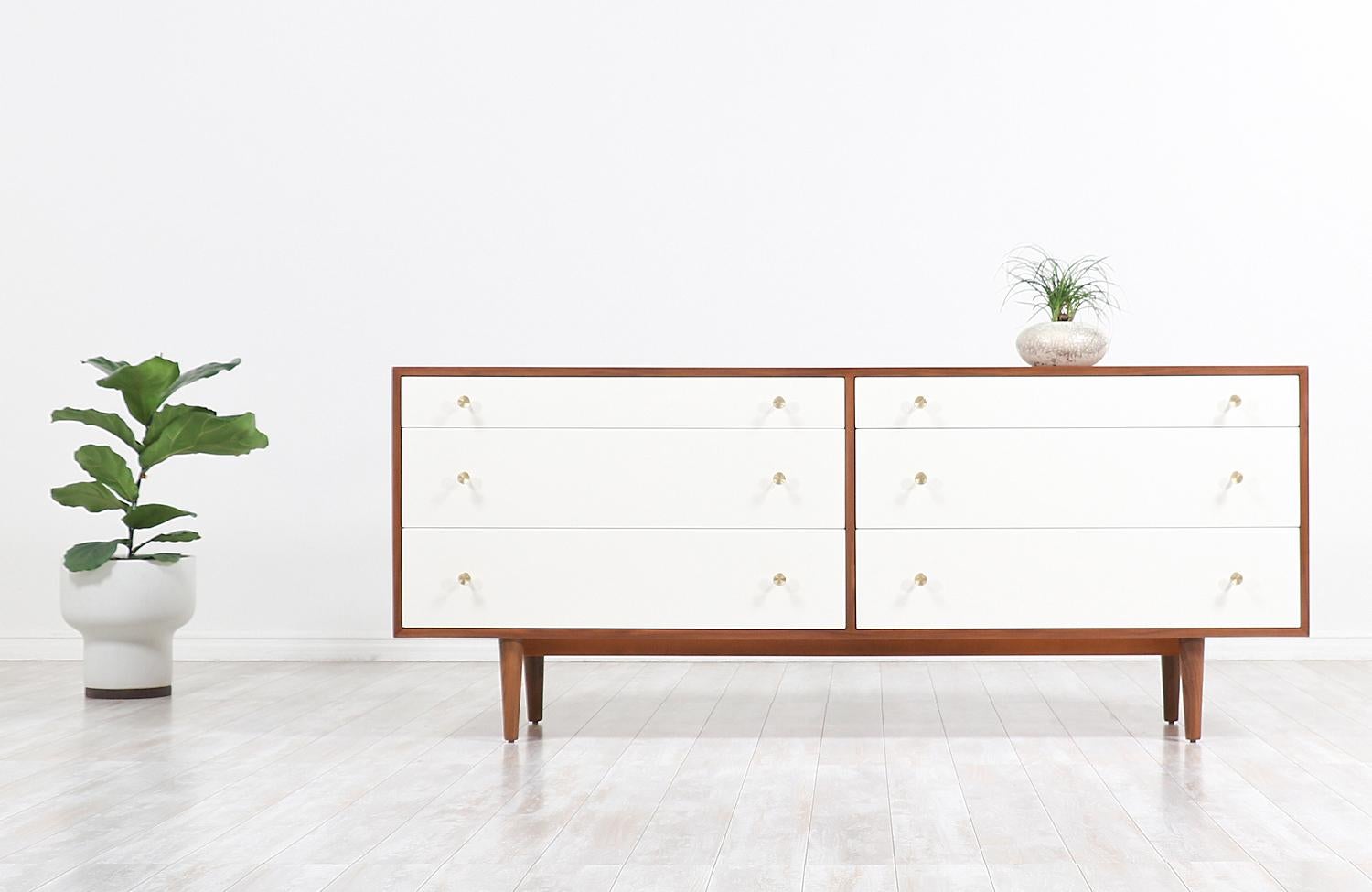 Handsome Mid-Century Modern dresser designed by Milo Baughman for Glenn of California in the United States, circa 1950s. This marvelous dresser features a sturdy walnut wood case with six ample drawers that create a dynamic structure as they come in