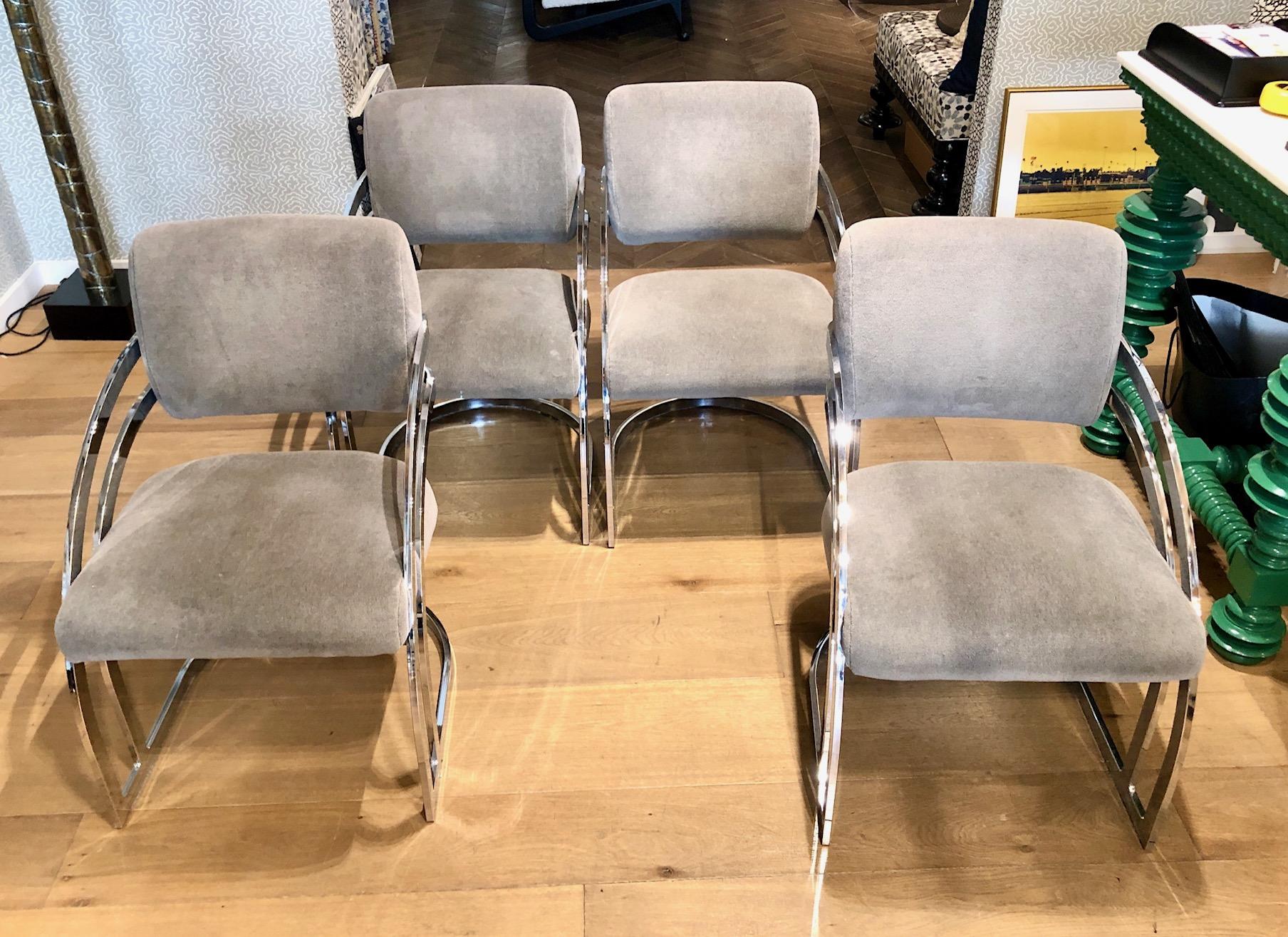 Very comfortable curved chrome cantilever dining chairs by Cal-Style. Professionally upholstered in a grey colored velvet fabric provides a modern vibe with its chrome frames. The chair backs have a triple bar design and waterfall cantilevered