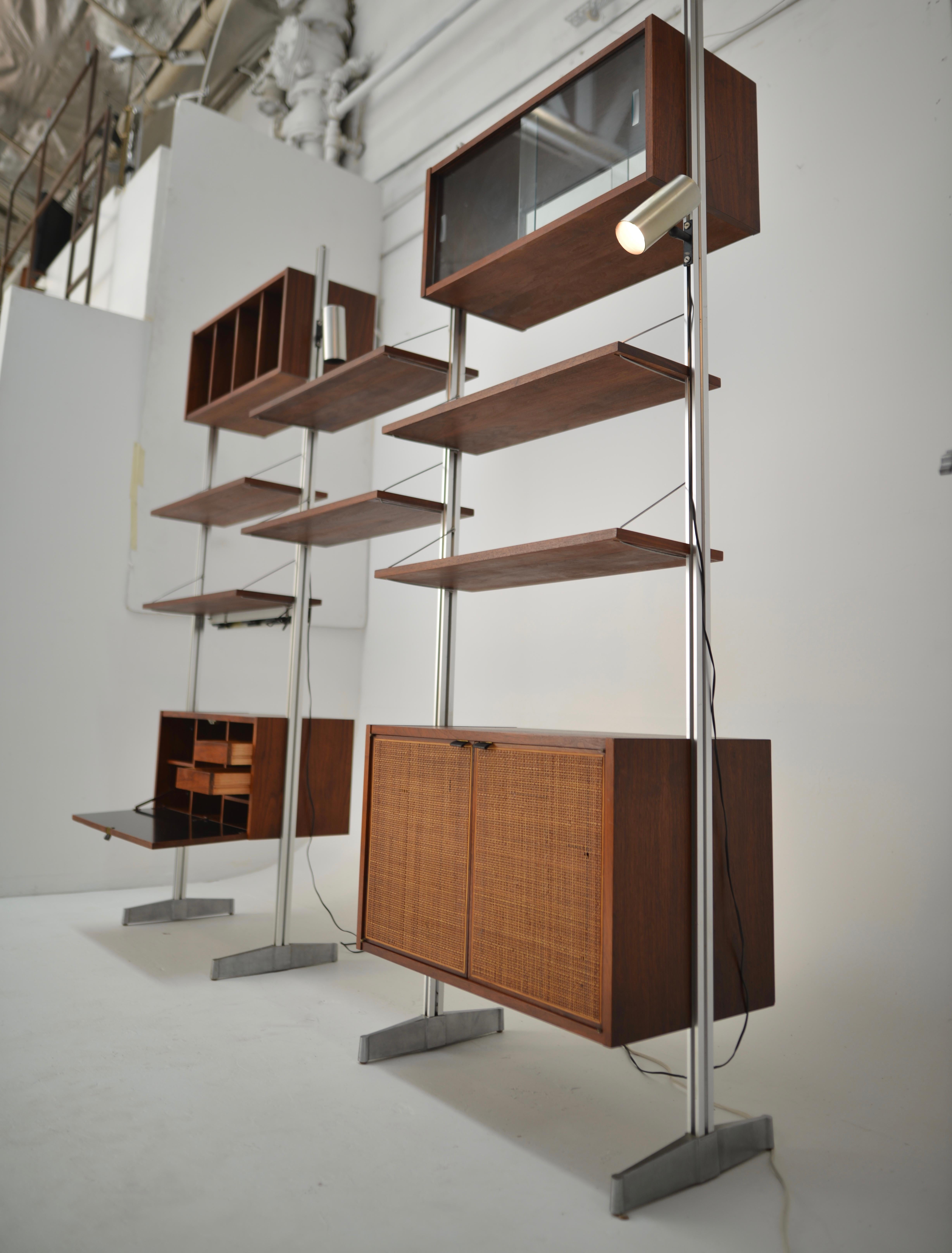 This is a stunning modern wall unit by Founders, a Division of Knoll International, by Milo Baughman.
Aluminium supports with walnut shelves, cabinets and drawers, with adjustable lights.