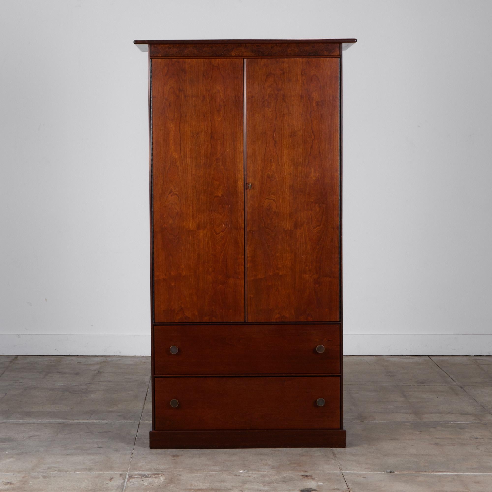 Walnut and burl wood armoire by Milo Baughman for Directional, c.1960s, USA, features eight drawers down the middle of the interior of the cabinet, three upper shelves, two with dividers as well as twenty petite separated compartments. There are two