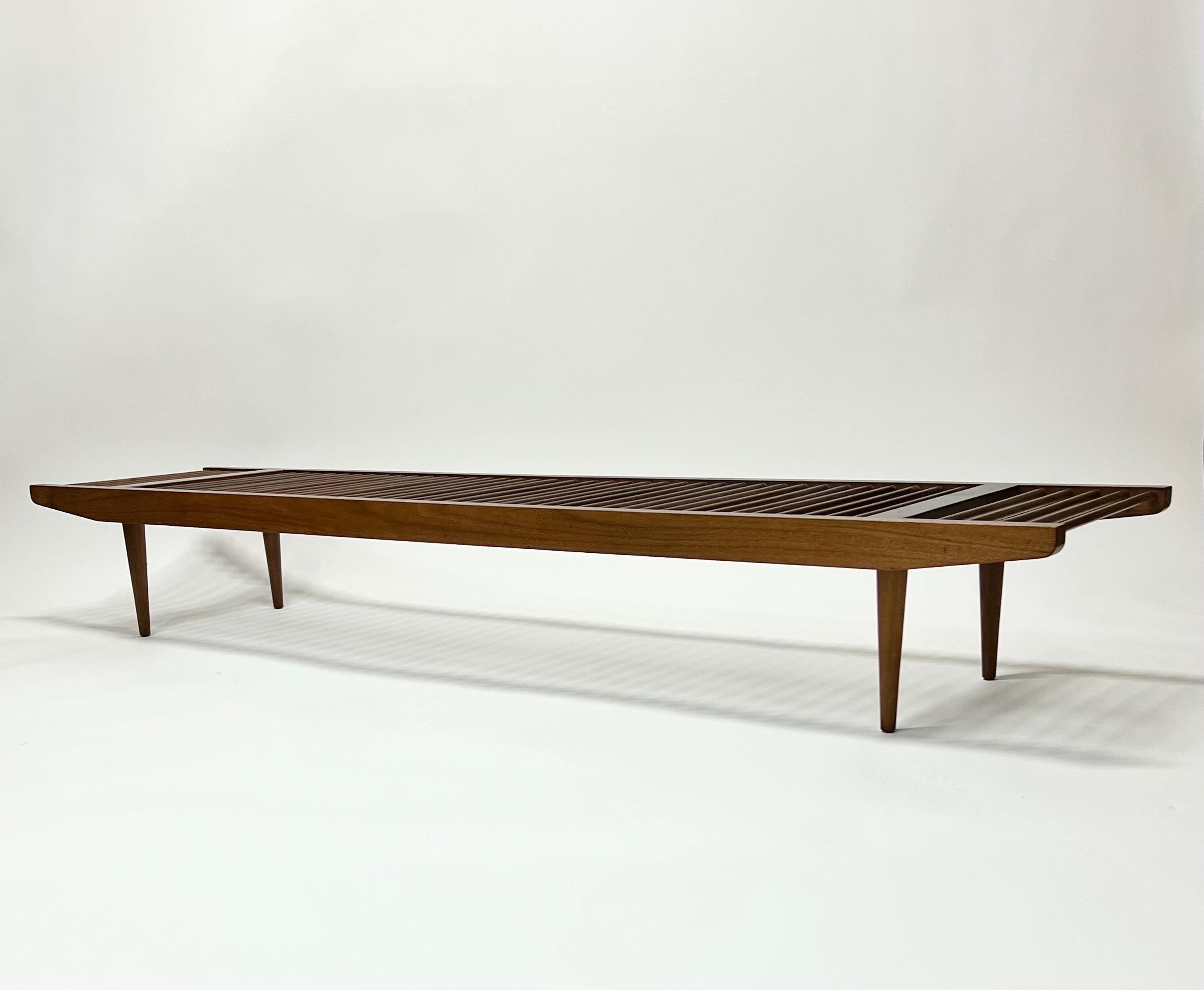 Stunning long and low walnut dowel bench designed by Milo Baughman for Glenn of California c1950s. All original condition with a wonderful patina and great lines. Legs unscrew for easy transport or storage. This is the largest of the 3 different