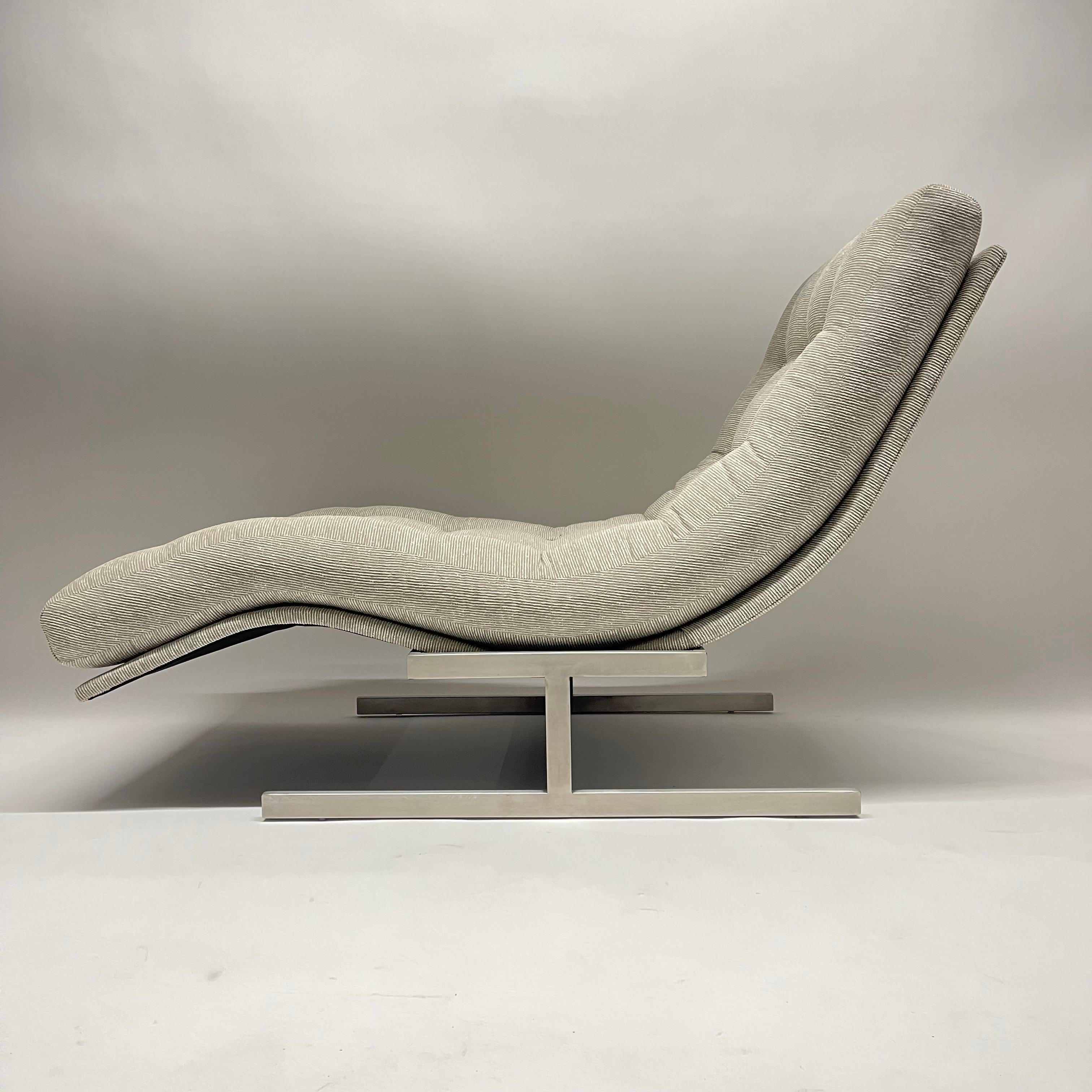 Iconic mid century wave chaise lounge rendered in woven grey fabric with a brushed stainless steel frame, circa 1970's.