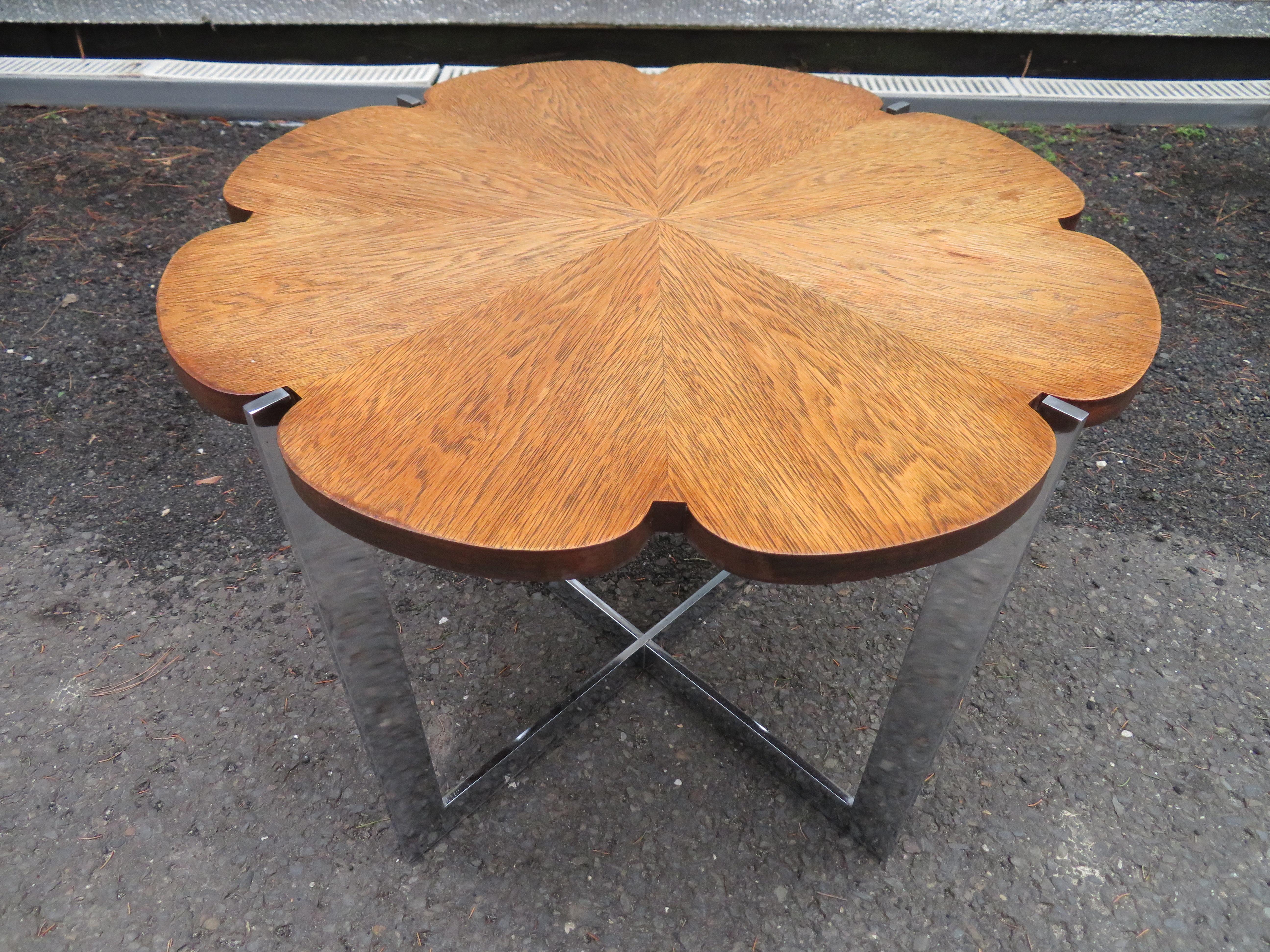 Fabulous Milo Baughman style chrome X base side table. This wonderful piece has a super heavy chrome base with a thick piece of vintage glass. We also have a matching walnut top flower table with same exact chrome base listed in another of our