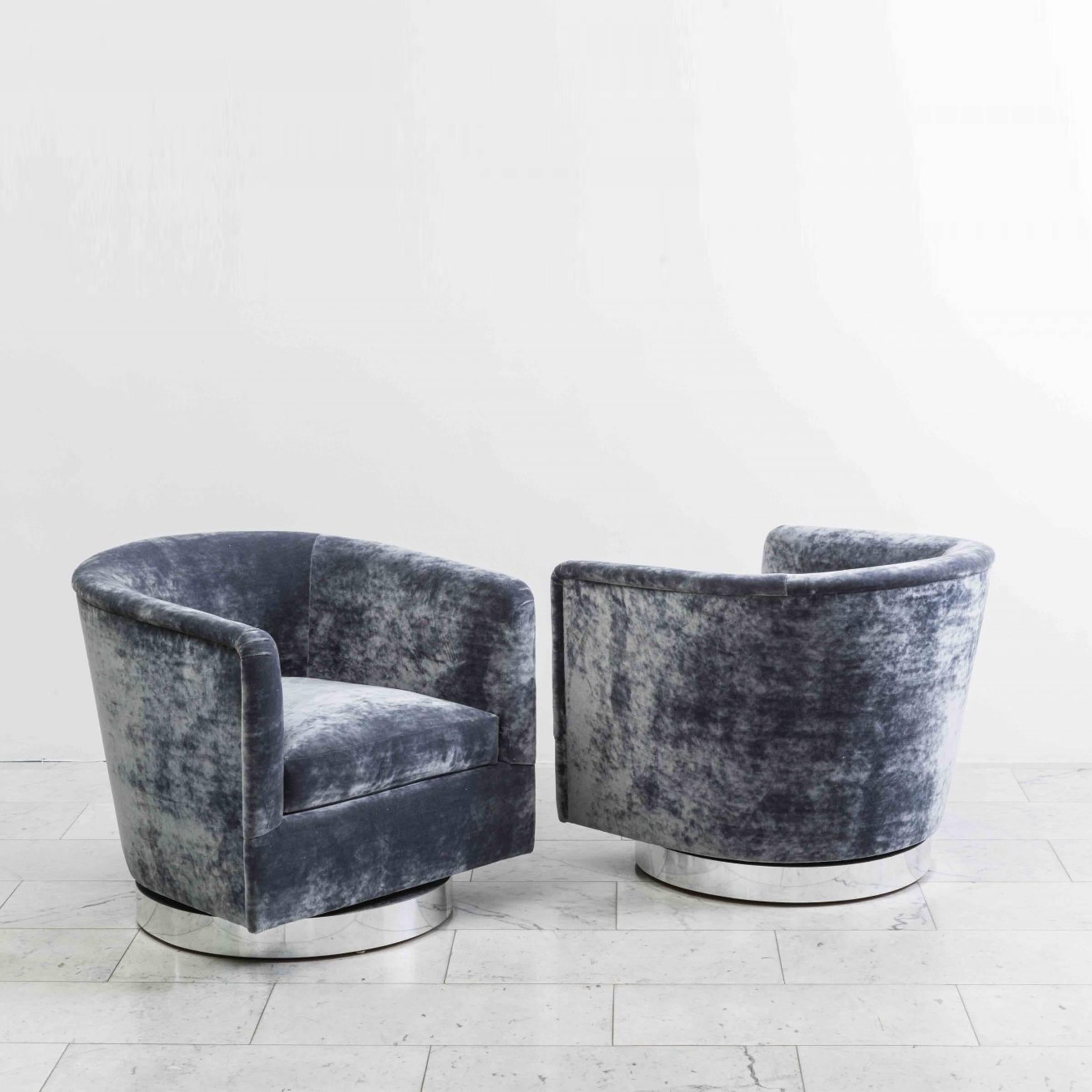 A beautiful pair of swivel chairs designed by Milo Baughman. Each chair has a circular chrome base that swivels with ease. Elegant in design, the chairs are also extremely comfortable, offering wonderful back support. The chairs feature new