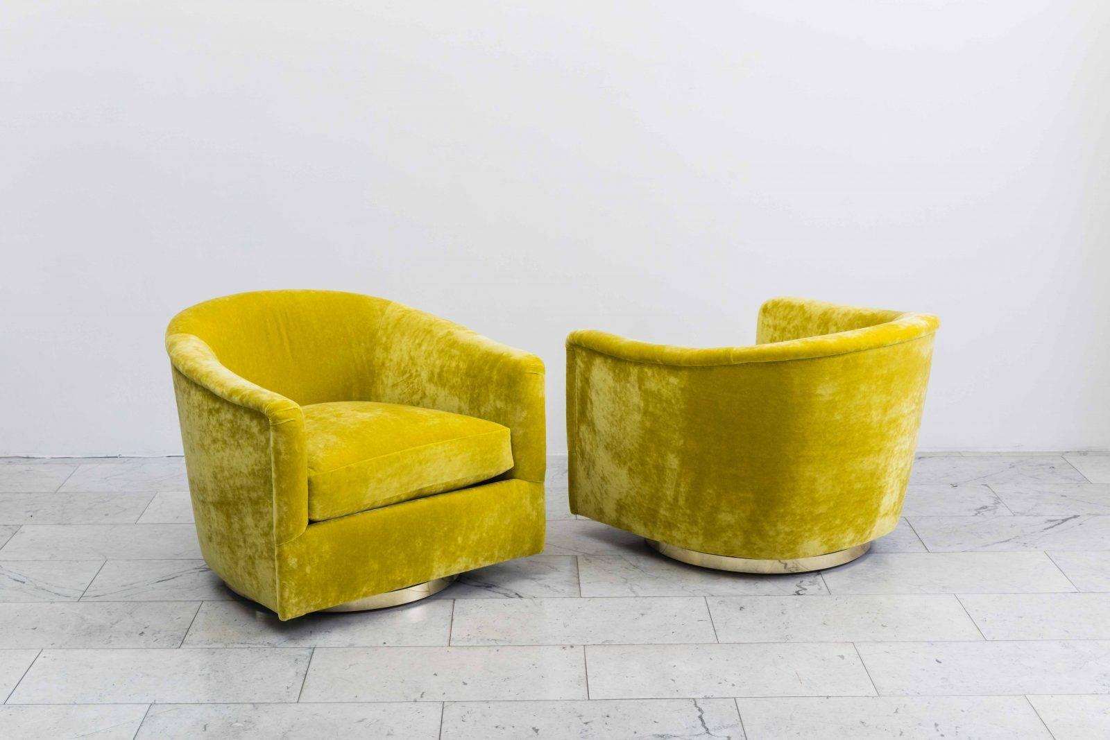 A beautiful pair of swivel chairs designed by Milo Baughman. Each chair has a circular bronze base that swivels with ease. Elegant in design, the chairs are also extremely comfortable, offering wonderful back support. The chairs feature new