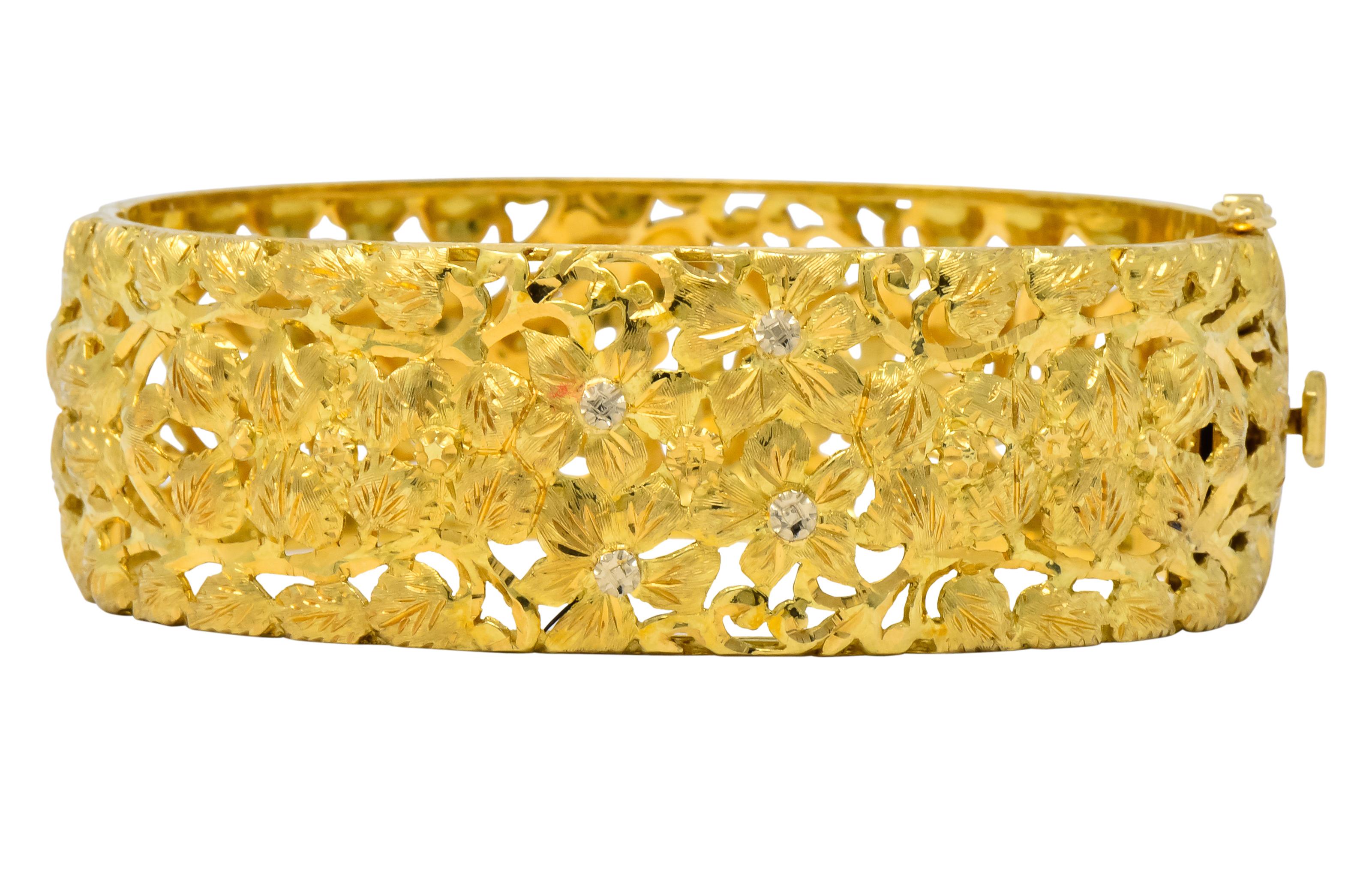 Featuring a wide hinged bangle with pierced floral design 

Etched details contrast with brushed finish

Completed by concealed clasp and fold-over safety

Fully signed Milor, Italy, and stamped 750

Inner Circumference: 7 inches

Width: 7/8