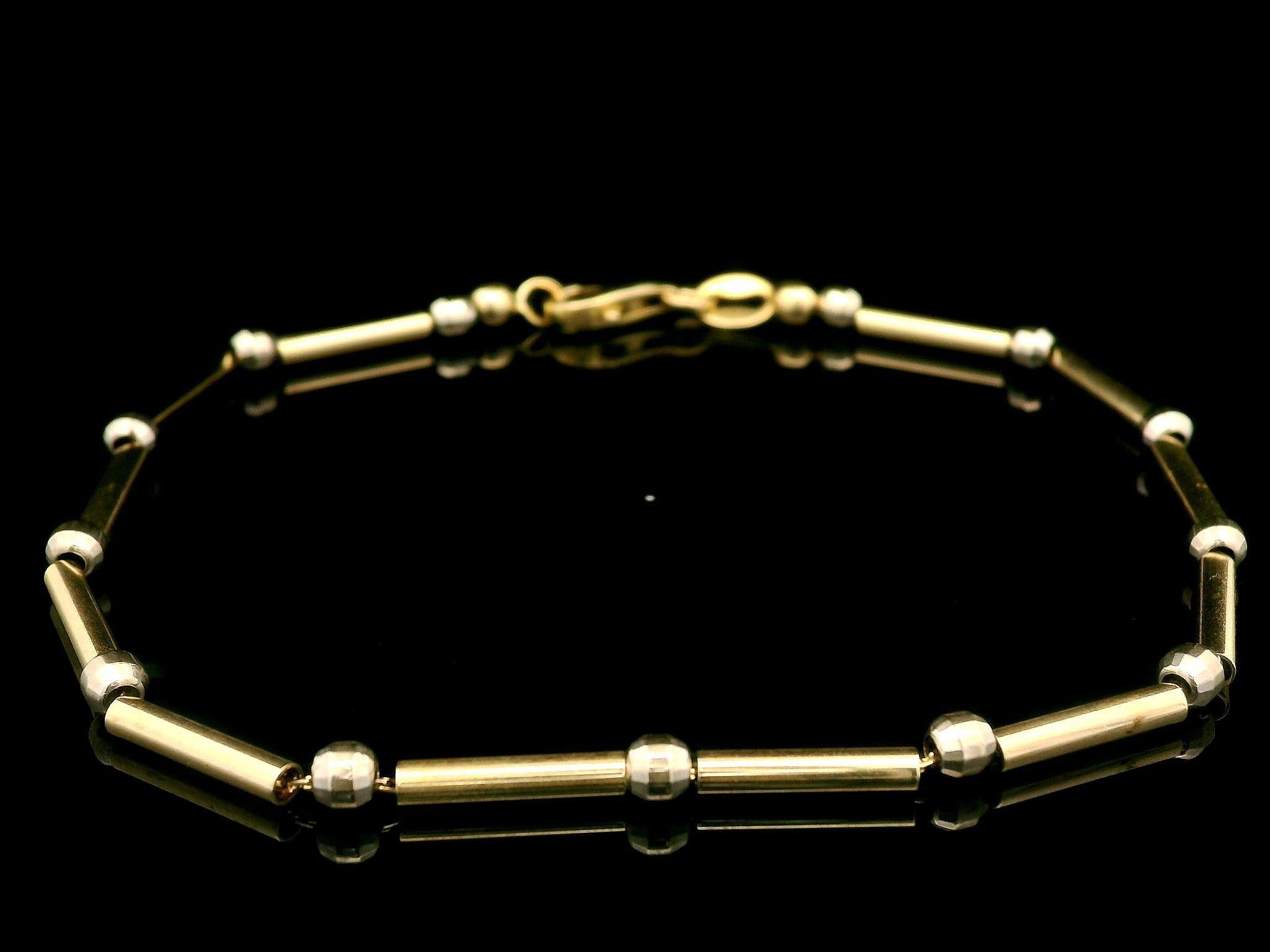 Material: Solid 14K Yellow Gold & White Gold Beads
Weight: 4.3 Grams
Chain Type: Alternating Tube & Faceted Bead Links over a Cable Link
Chain Length: Measures 7.25 Inches Next to a Ruler, Will Comfortably Fit a 7.0 inches Wrist (fitted on a