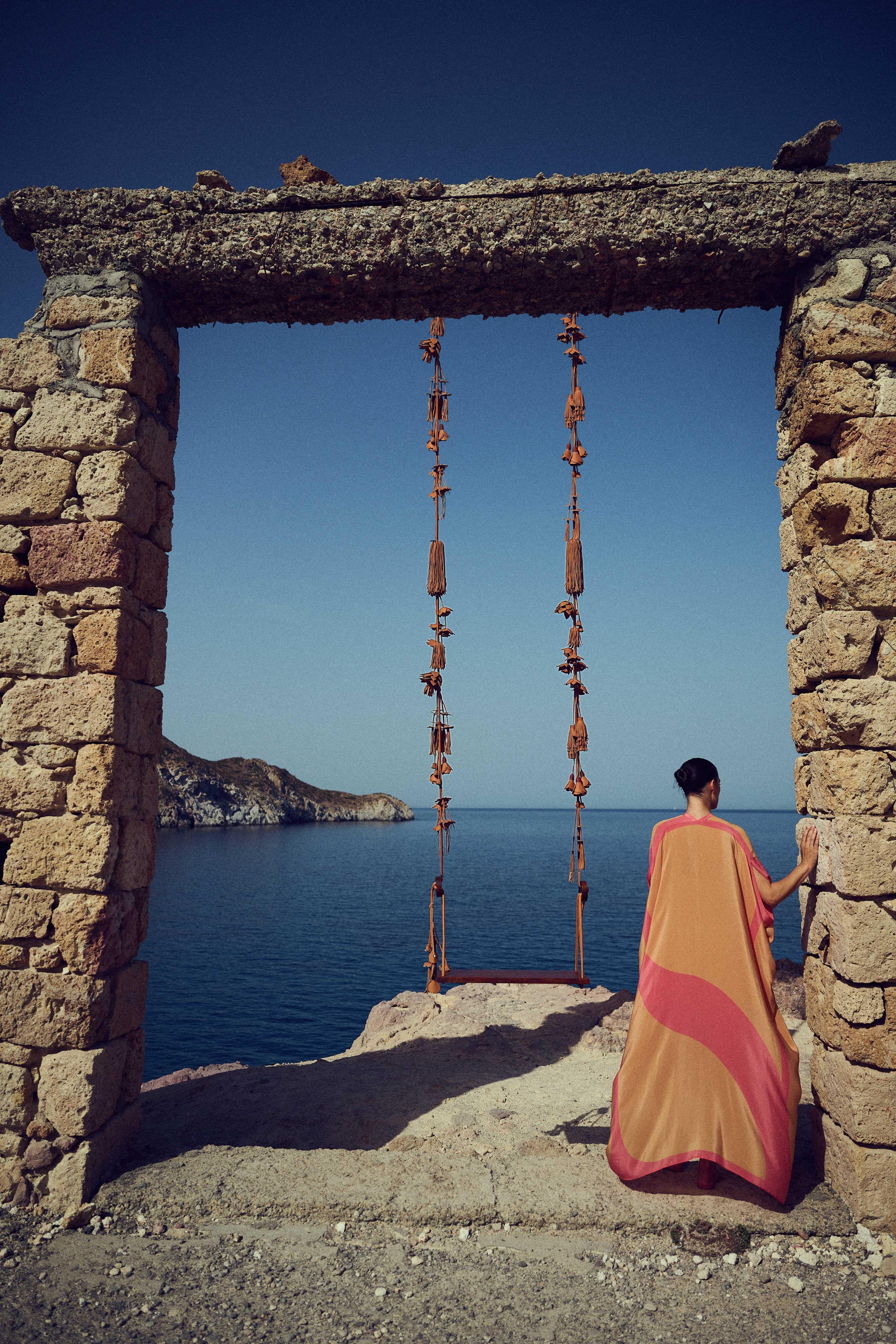 Wooden seat made from solid oak suspended from natural leather rope richly embellished with leather tassels and flowers. All leather detailing is tan-coloured.

On the lacey coastlines of Milos, the pure white rocks rise effortlessly, soft and