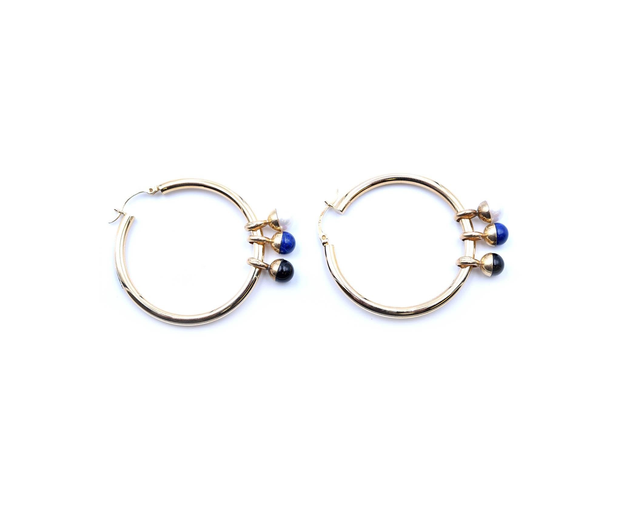 Designer: Milros
Material: 14k yellow, white and rose gold
Gemstones: black onyx and lapis
Pearl: two 6.40mm round cultured pearls
Dimensions: each hoop measures 40mm long and 3mm wide
Weight: 4.67 grams
