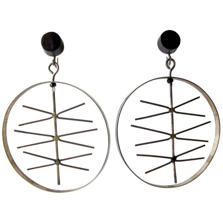 Rare, abstract modernist kinetic sterling silver and ebony earrings created by Milton Cavagnaro of Mill Valley, California.  Earrings inner decorative piece spins freely within the sterling silver ring.  They measure 2.75