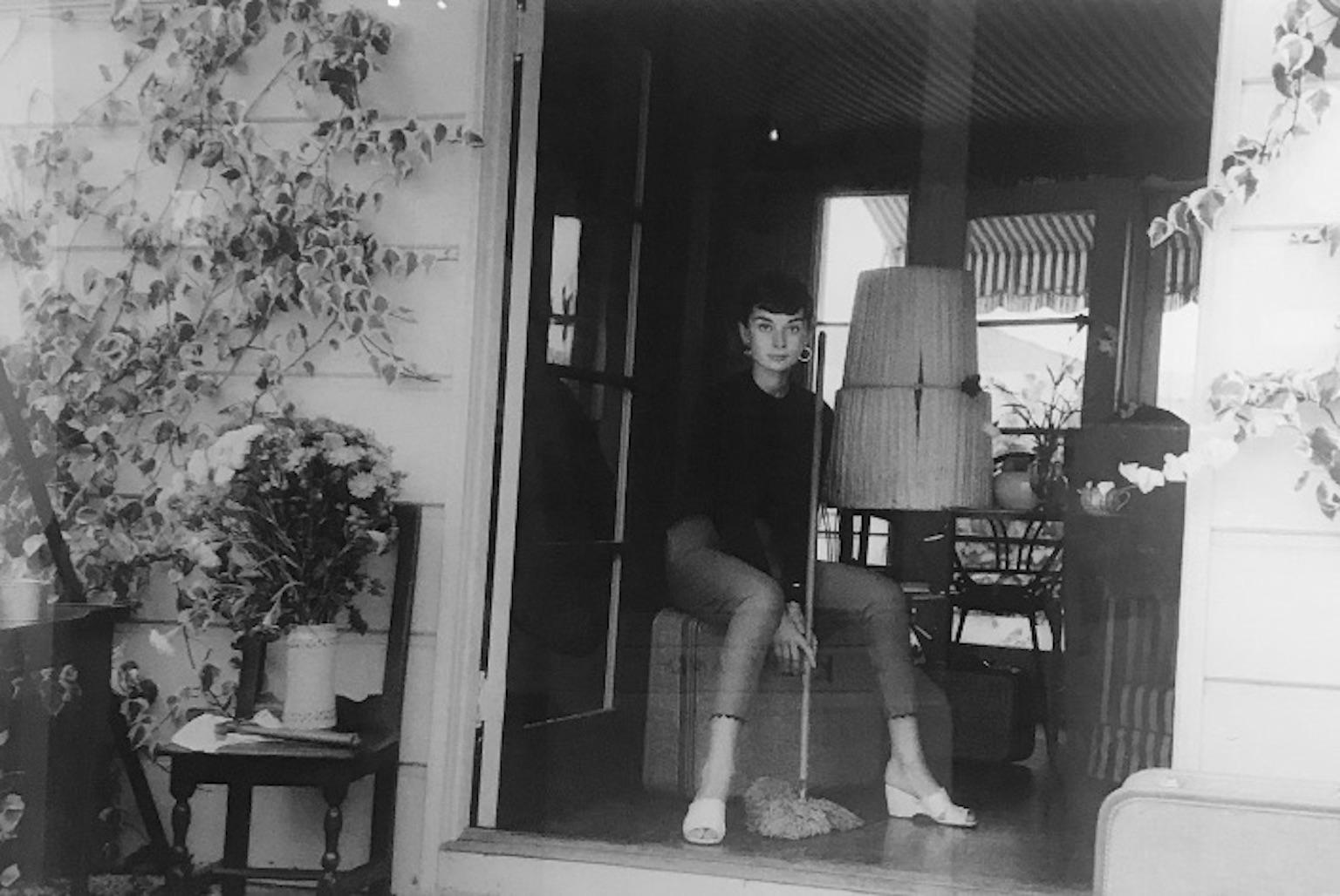 Milton Greene Portrait Photograph - Audrey Hepburn with Broom
